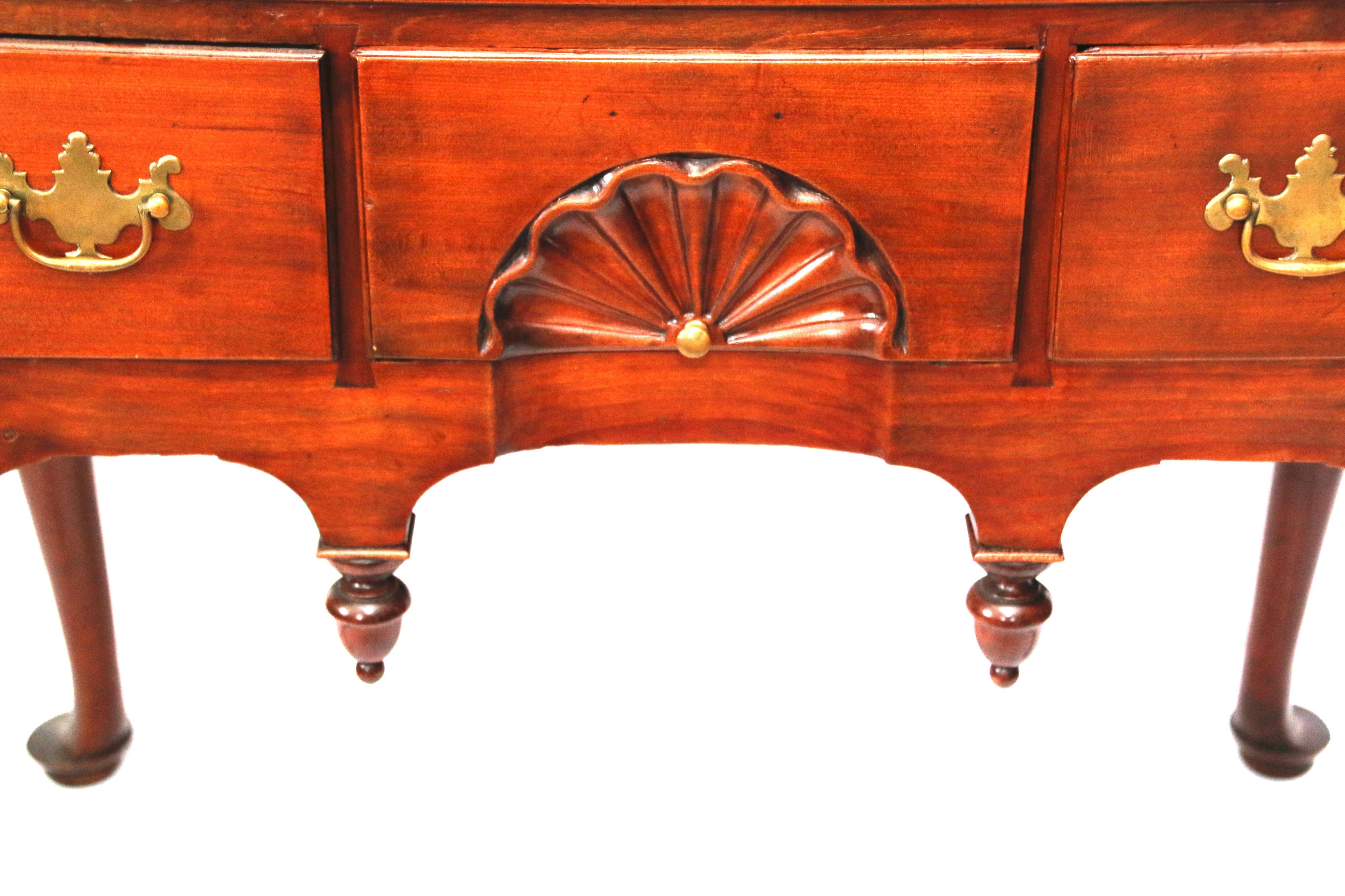 Connecticut Queen Anne cherry lowboy, The rectangular top with front inset corners projecting above the conforming case, fitted with a single long drawer above three aligned short drawers, the centre most with an inset fan above an apron carved with