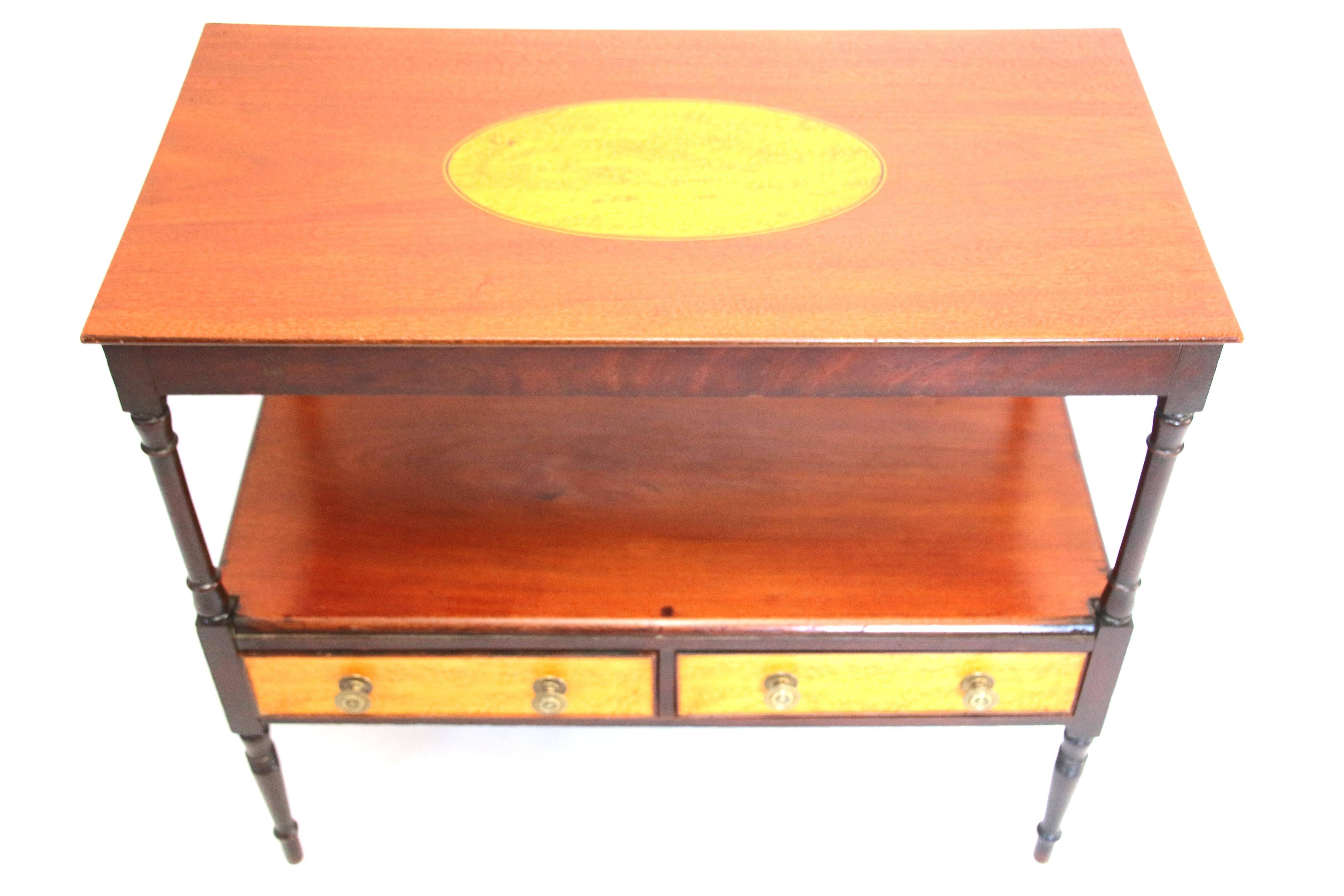 Wonderful Sheraton mahogany diminutive server or butler's table with bird's-eye maple inlaid oval top and lower tier with two bird's-eye maple drawer fronts on delicate turned legs,

circa 1810.

Measures: 29 inches H x 17 1/2 inches D x 33 1/4