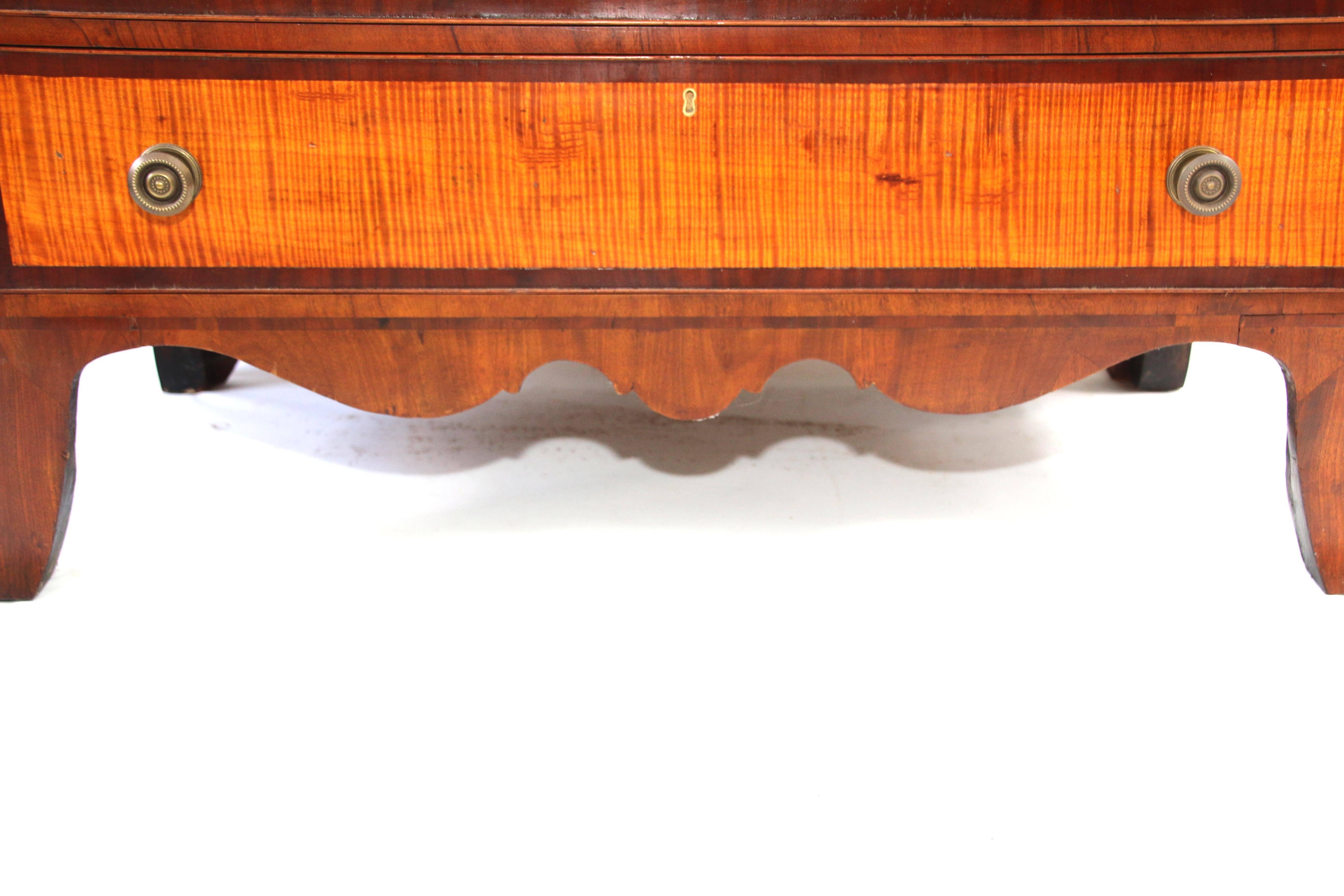 Tiger maple, cherry and mahogany Hepplewhite server. This fine server has a cherry case, and the face is banded with mahogany veneer, having three shallow drawers above two deep bottle drawers centered by two doors above two long drawers. All faced