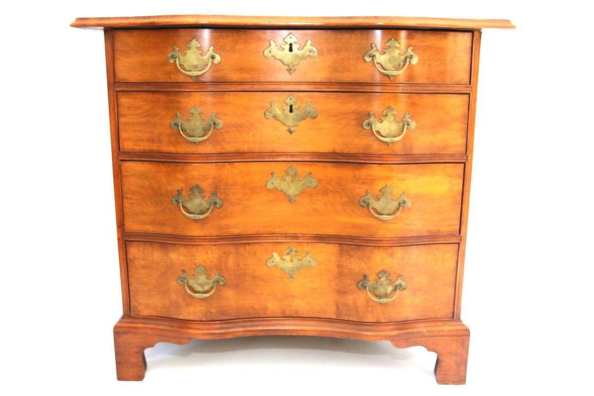 Chippendale maple and birch reverse serpentine chest of drawers of small size, the shaped top with thumb molded edge above the case with four graduated drawers, the molded base with bracket feet. 

Massachusetts, circa 1790. 

Measures: 30 1/4