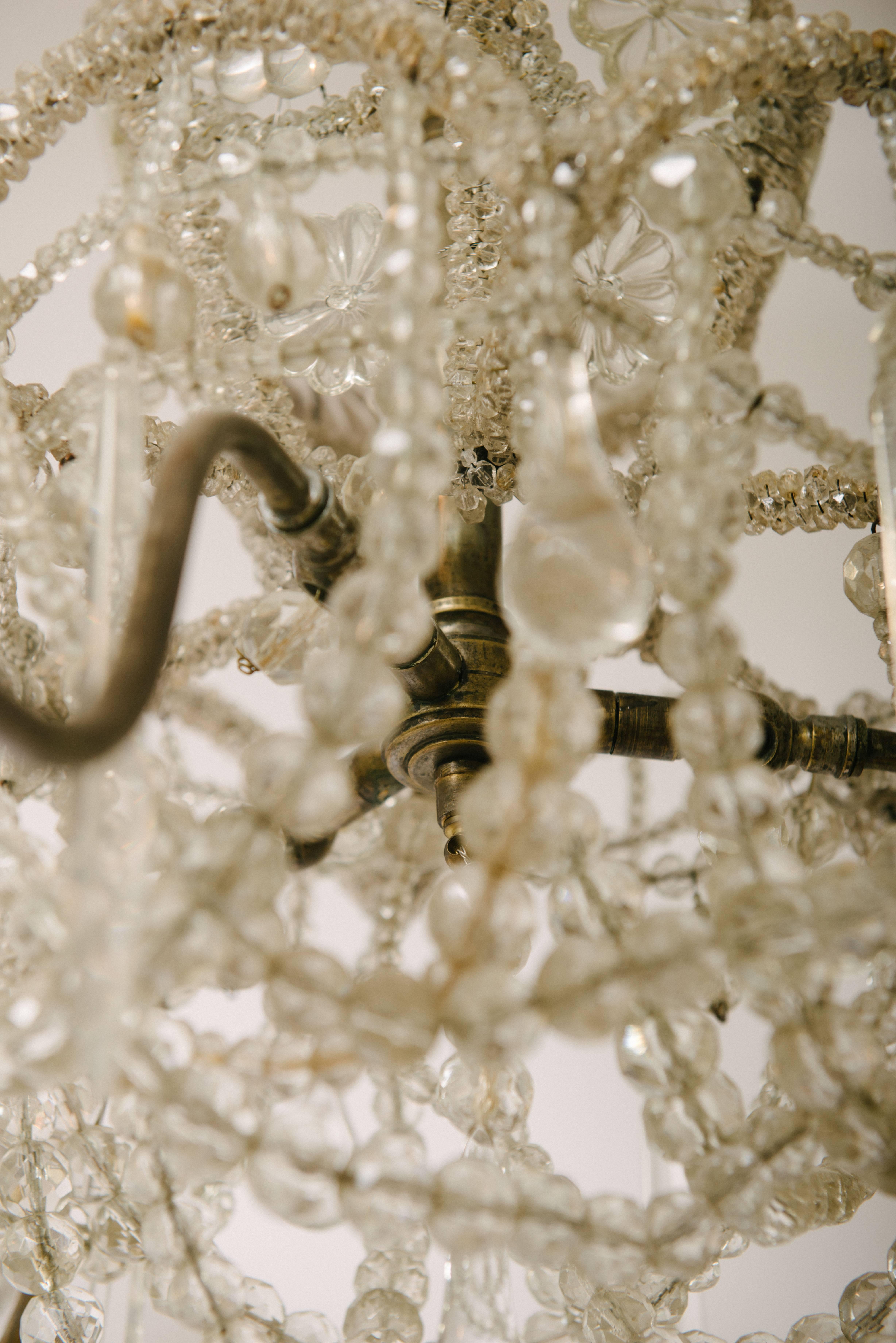 A heavily beaded and adorned crystal chandelier, circa 1920. This chandelier is newly wired using UL parts and wires.