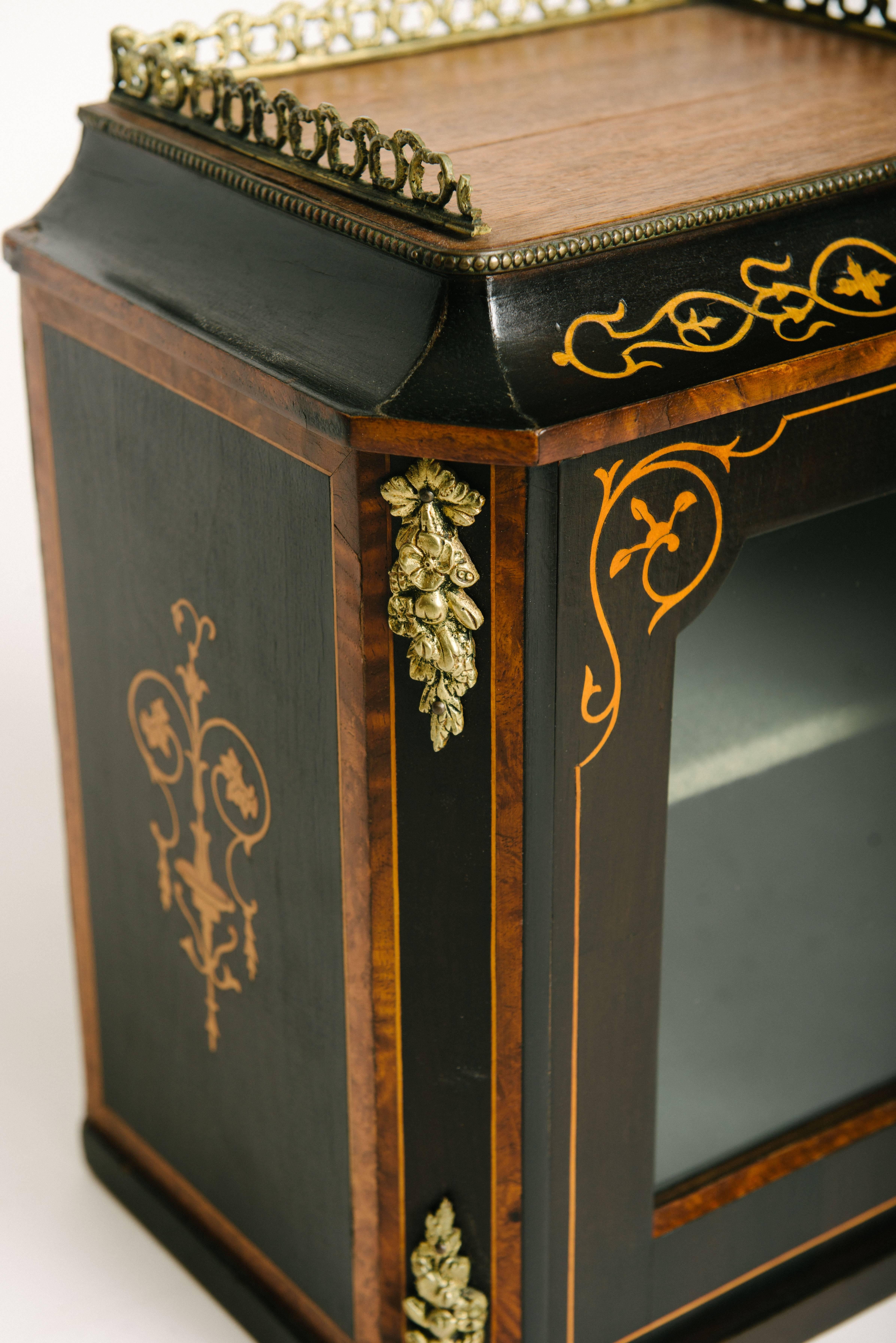 Handsome pair of 19th century Italian wall vitrines. Each petite cabinet features beautiful marquetry, bronze ormolu, glass door and single shelf.
