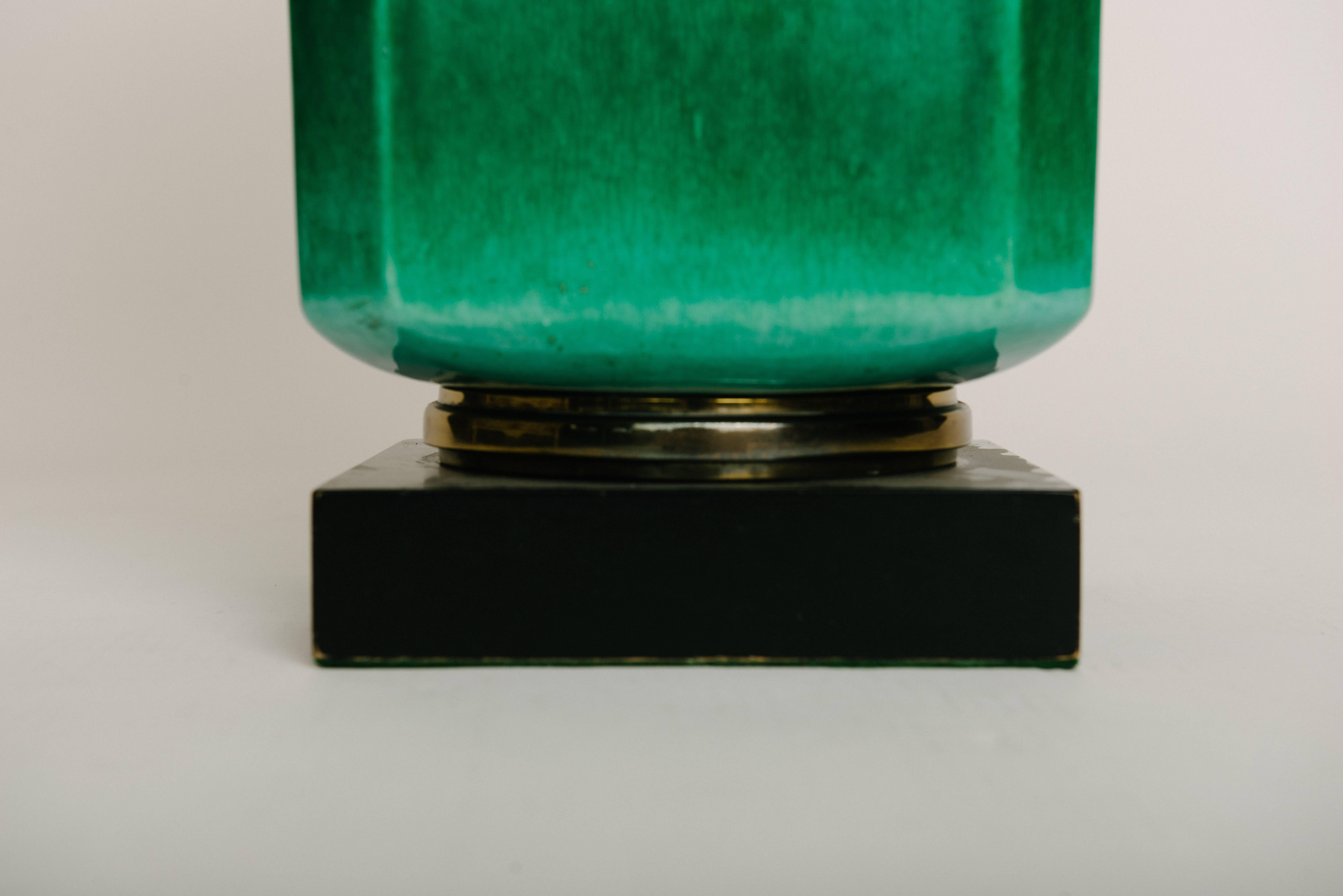 A beautiful emerald green glazed Asian Style pottery lamp with brass accents and cream linen shade.

Lamp base is 8.5 W x 8.5 D.