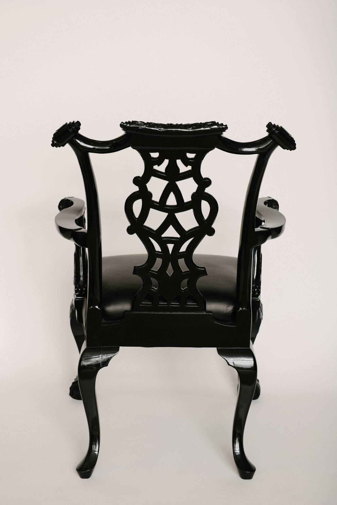 An intricately carved black lacquered 19th century Chippendale style chair newly upholstered in a buttery soft black leather.