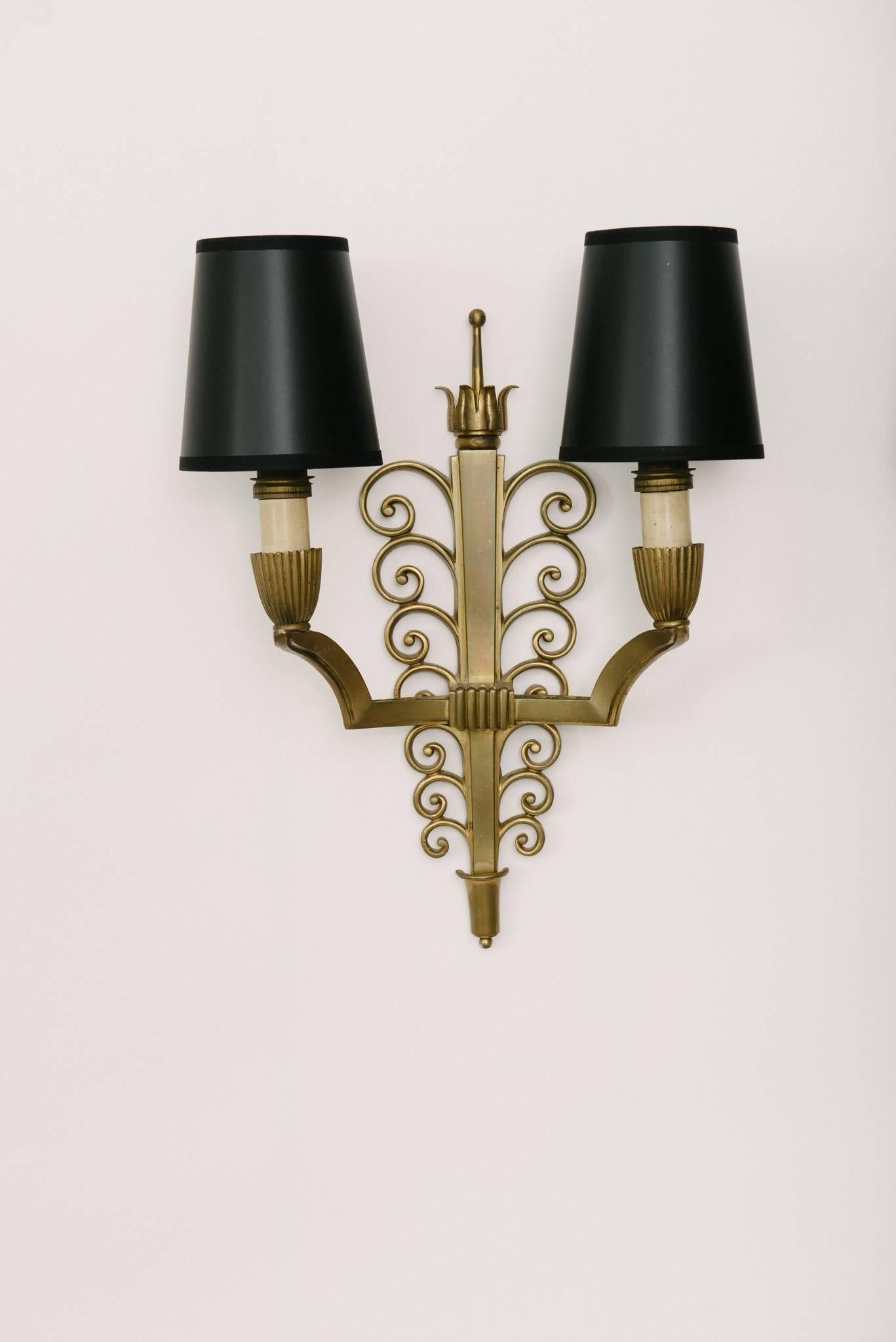 Pair of French 1940s bronze Poillerat wall sconces, newly wired with black paper shades.

