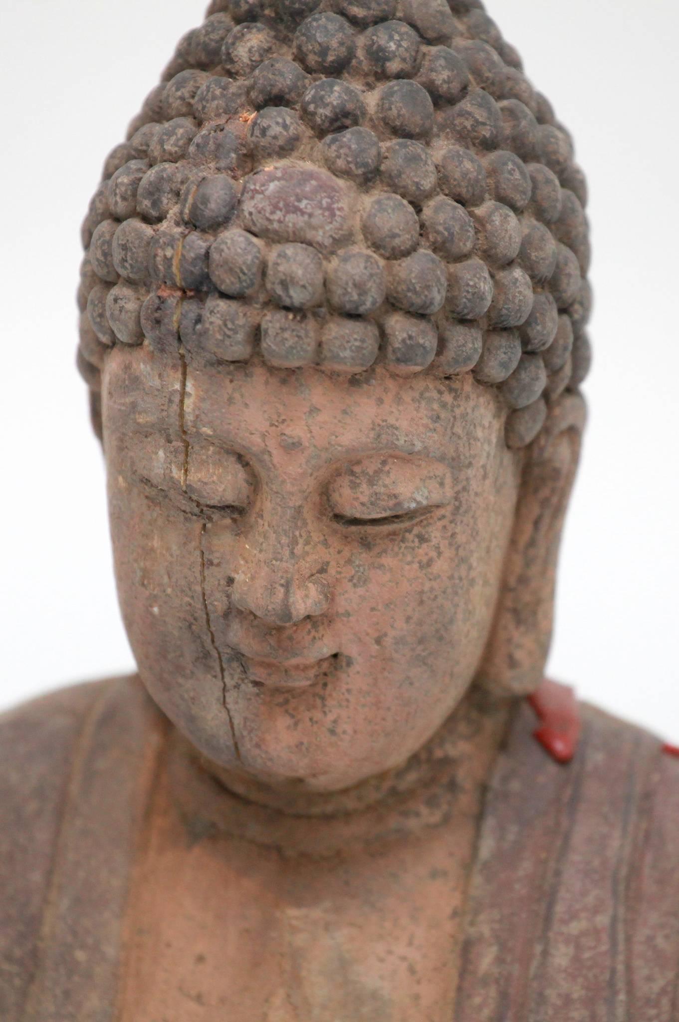 A 25.25 inch tall antique carved polychrome standing Buddha Amitabha. The Buddha of infinite light.