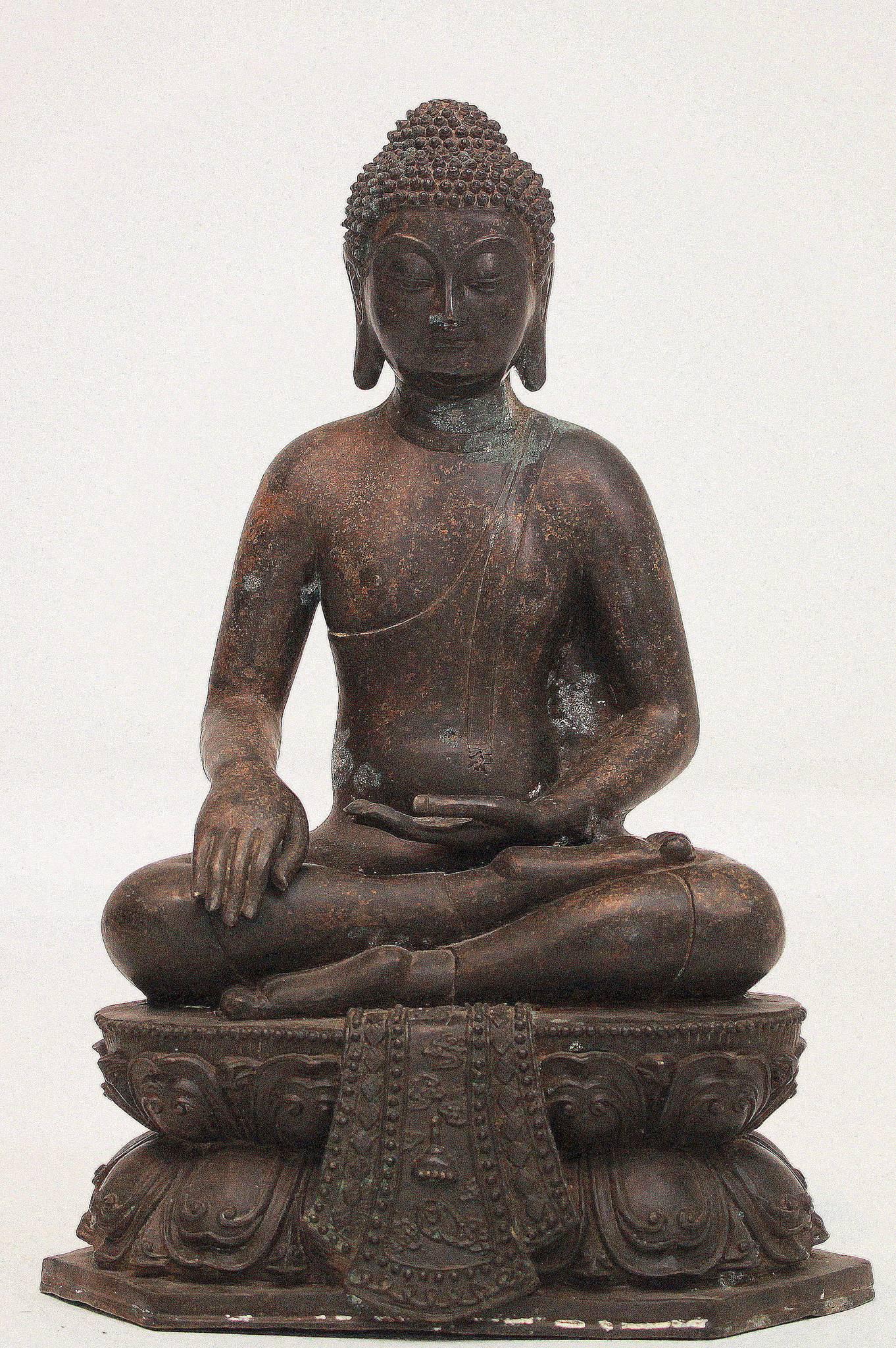A 19th Century or earlier sitting bronze Buddha on a double lotus pedestal. Measures: 21