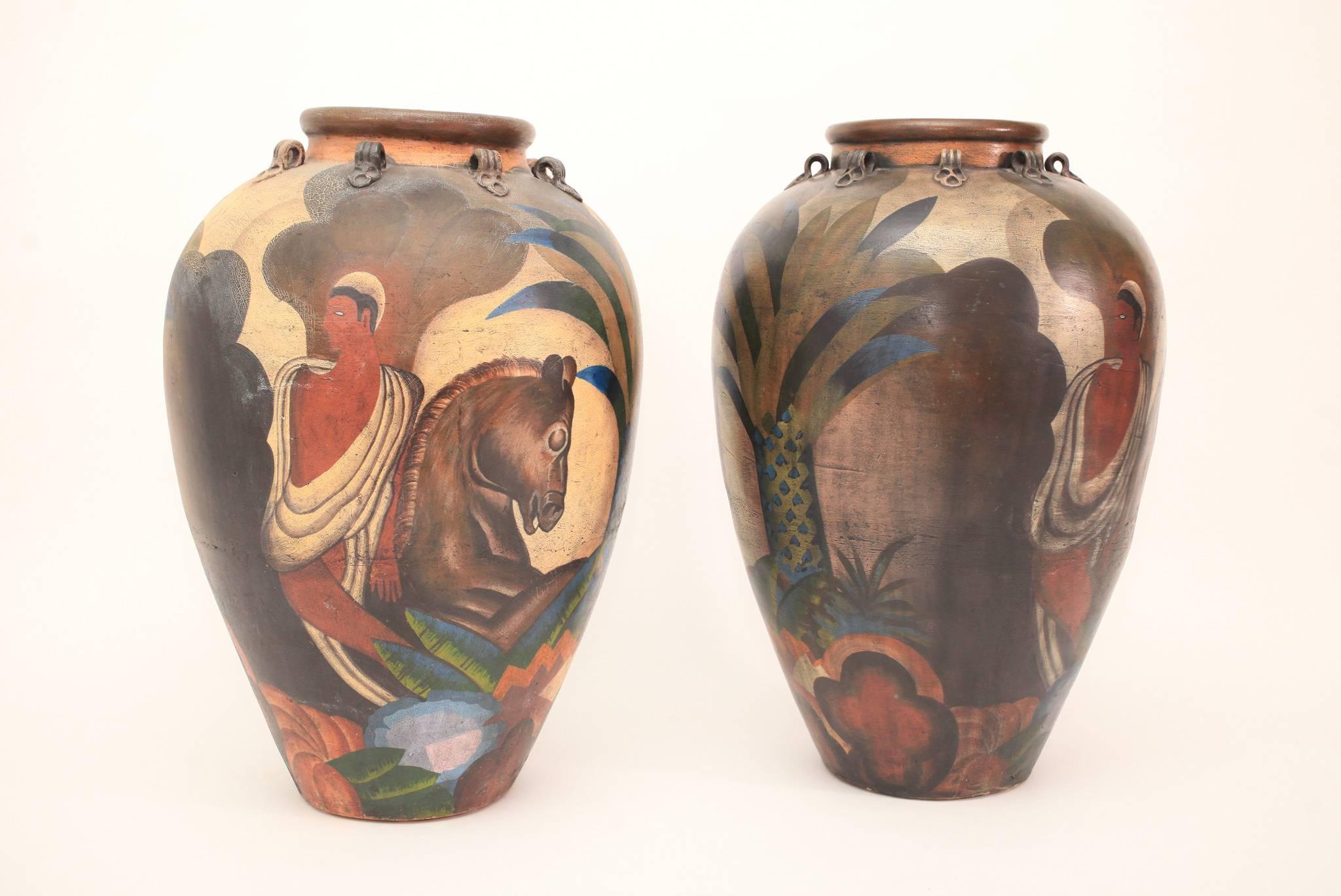 A tall pair of terracotta antique Mediterranean olive jars hand painted in the Deco style with a handsome male figure, horse and tropical foliage. Measures: 33.5
