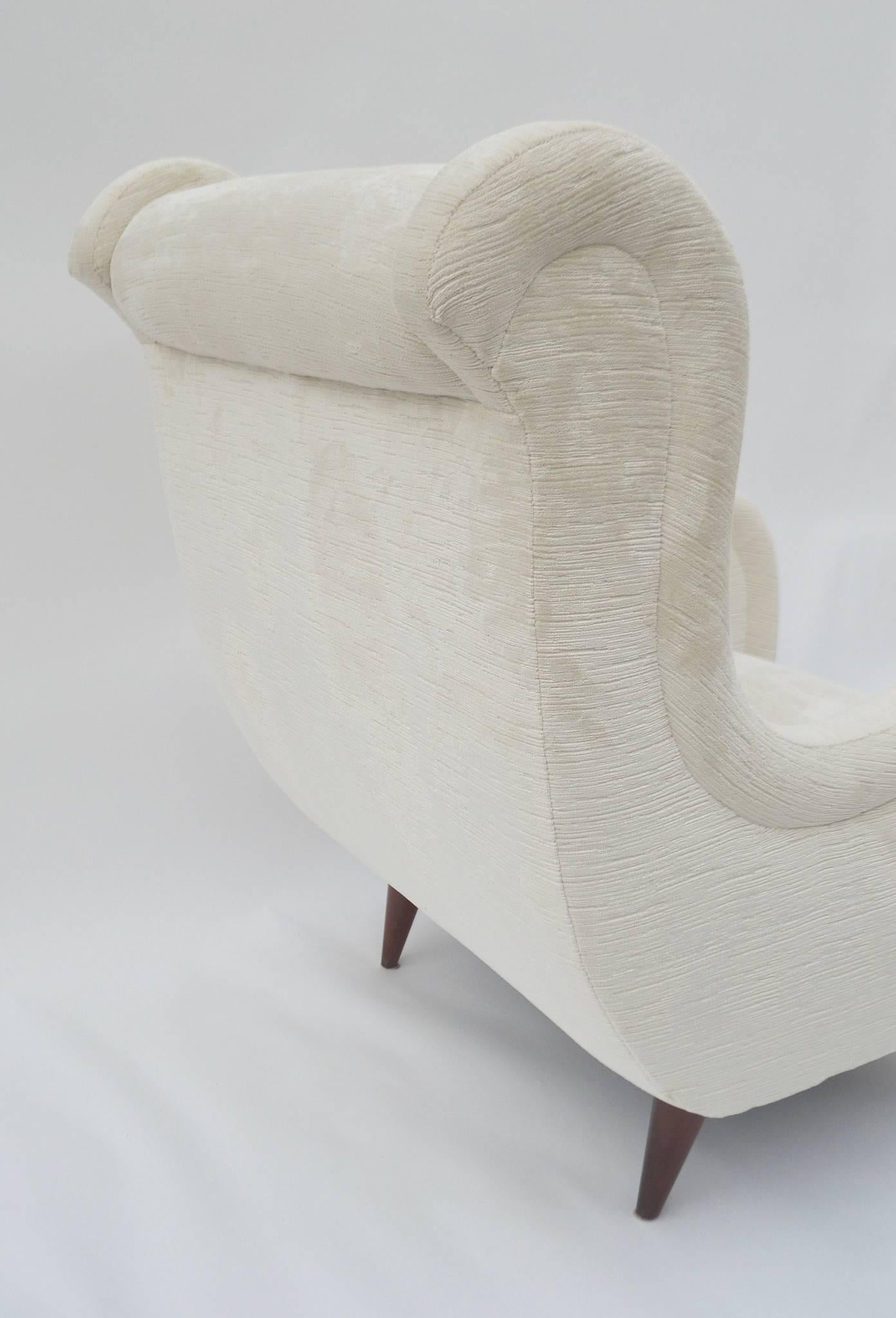 A pair of Italian lounge chairs attributed to Paola Buffa, circa 1965. These chairs have been professionally rebuilt and reupholstered in a striated creamy white/ecru chenille velvet.
