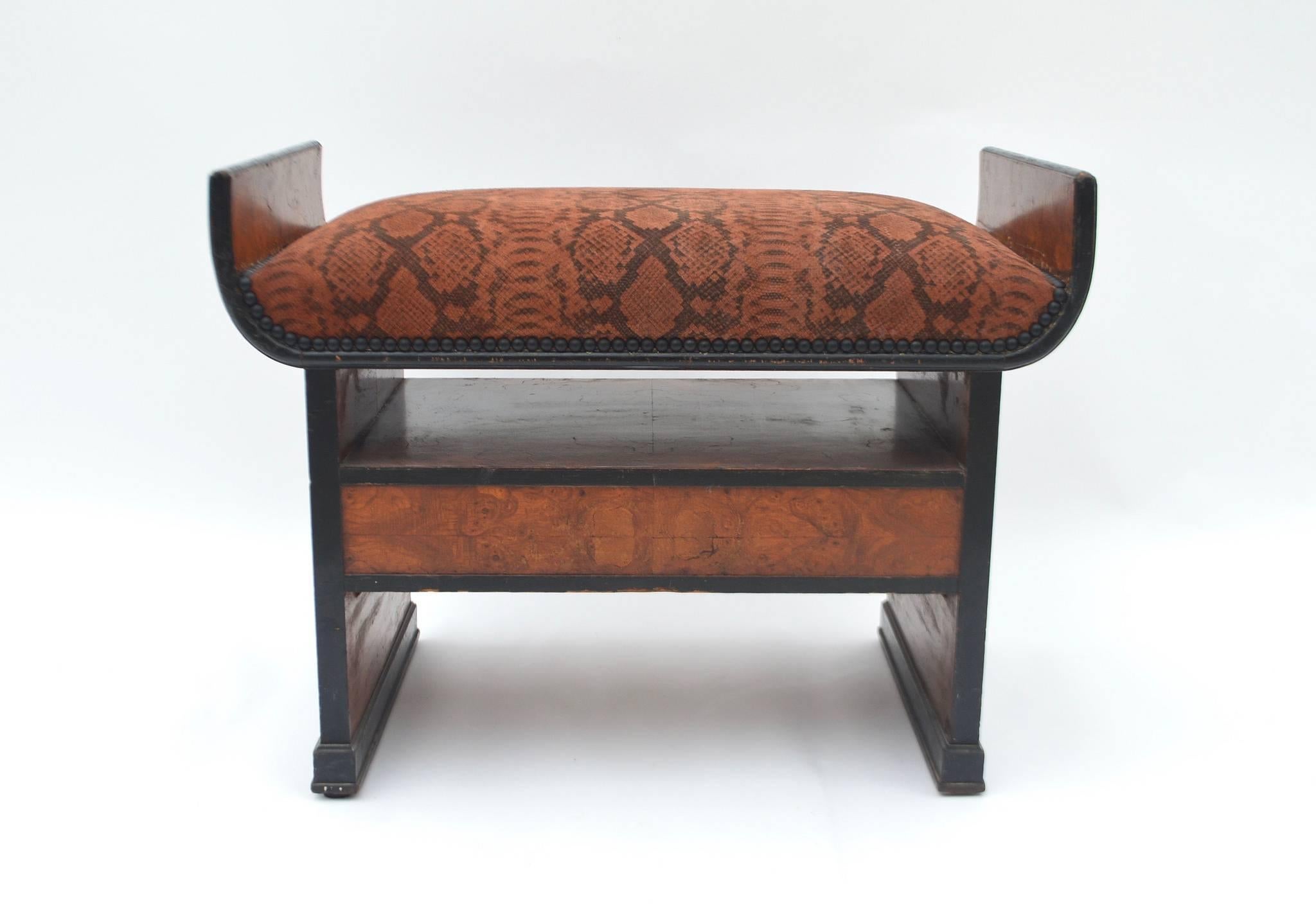 A period Art Deco black patinated and burl wood seat/ottoman with drawer and bronze pull. This handsome seat has been newly upholstered in a snake printed burnt sienna suede pigskin hide.