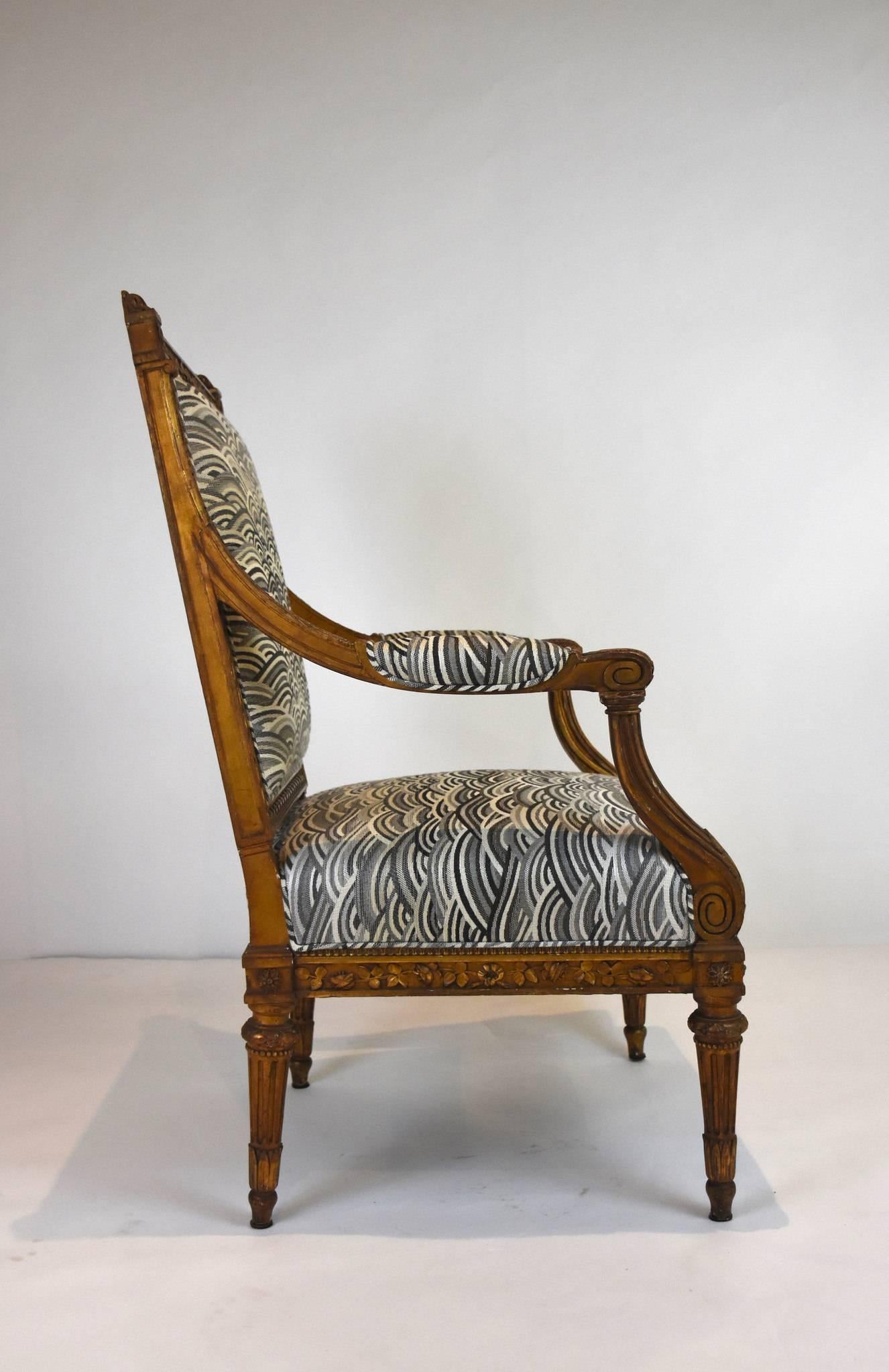A 19th century Louis XVI style giltwood fauteuil, newly upholstered with a black, white, and gray organic medium weight woven fabric.
