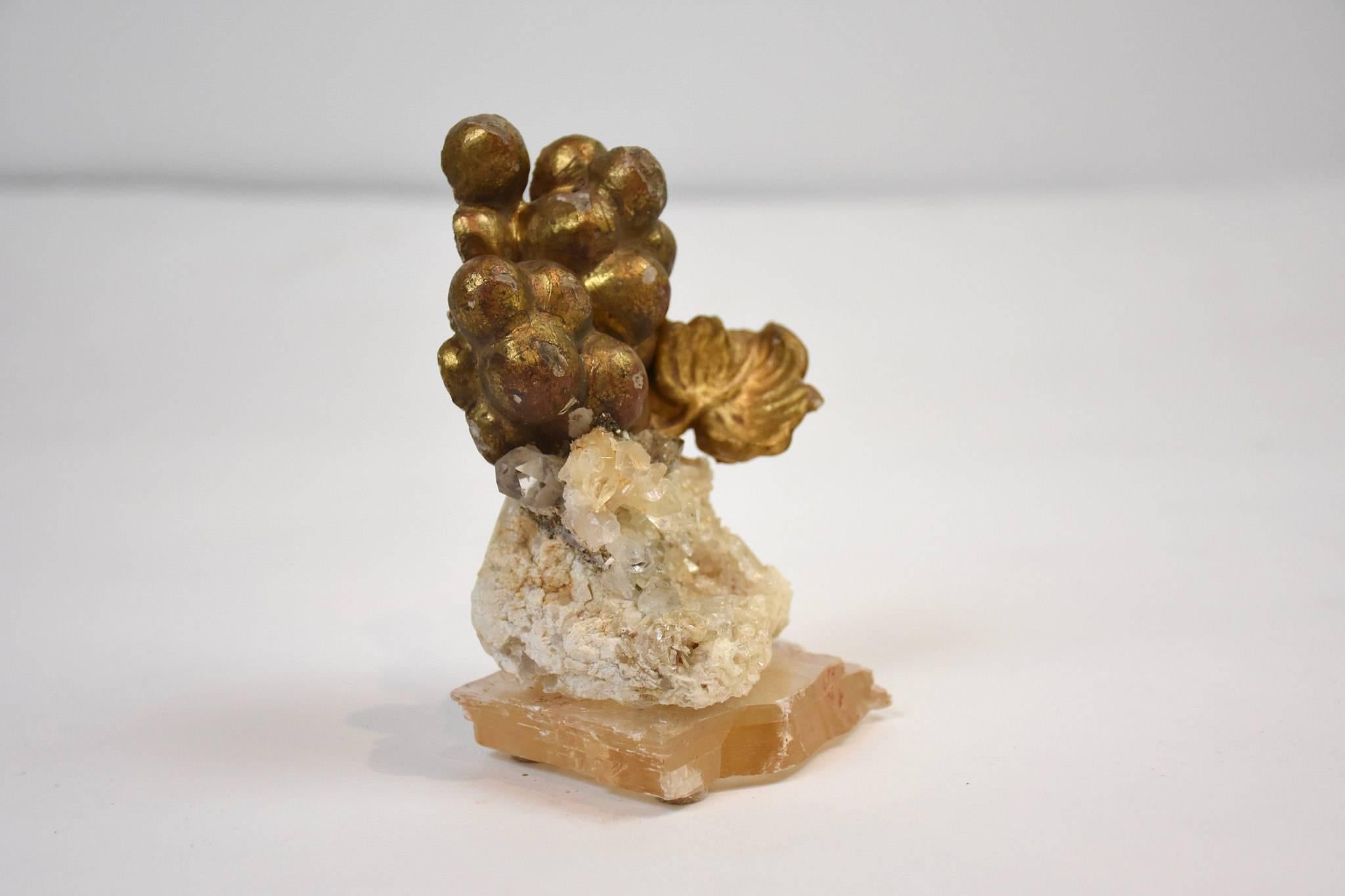 18th century Italian giltwood grape fragment decorated with quartz crystals in matrix and set on a natural forming selenite base. A beautiful antique artifact that has been taken away from it's original context and changed into an organic work of