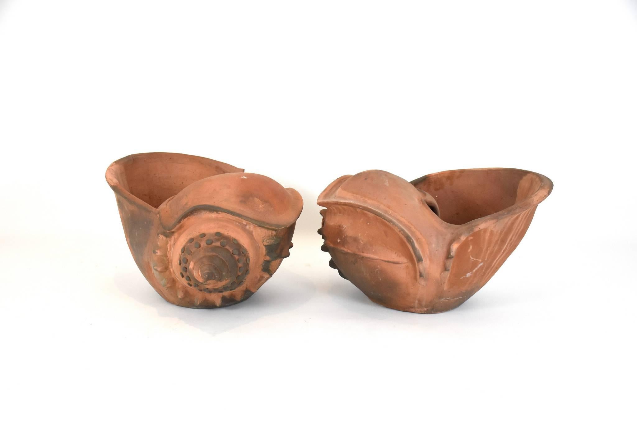 A pair of vintage terracotta shell jardiniere planters once owned by French decorator Madeleine Castaing.