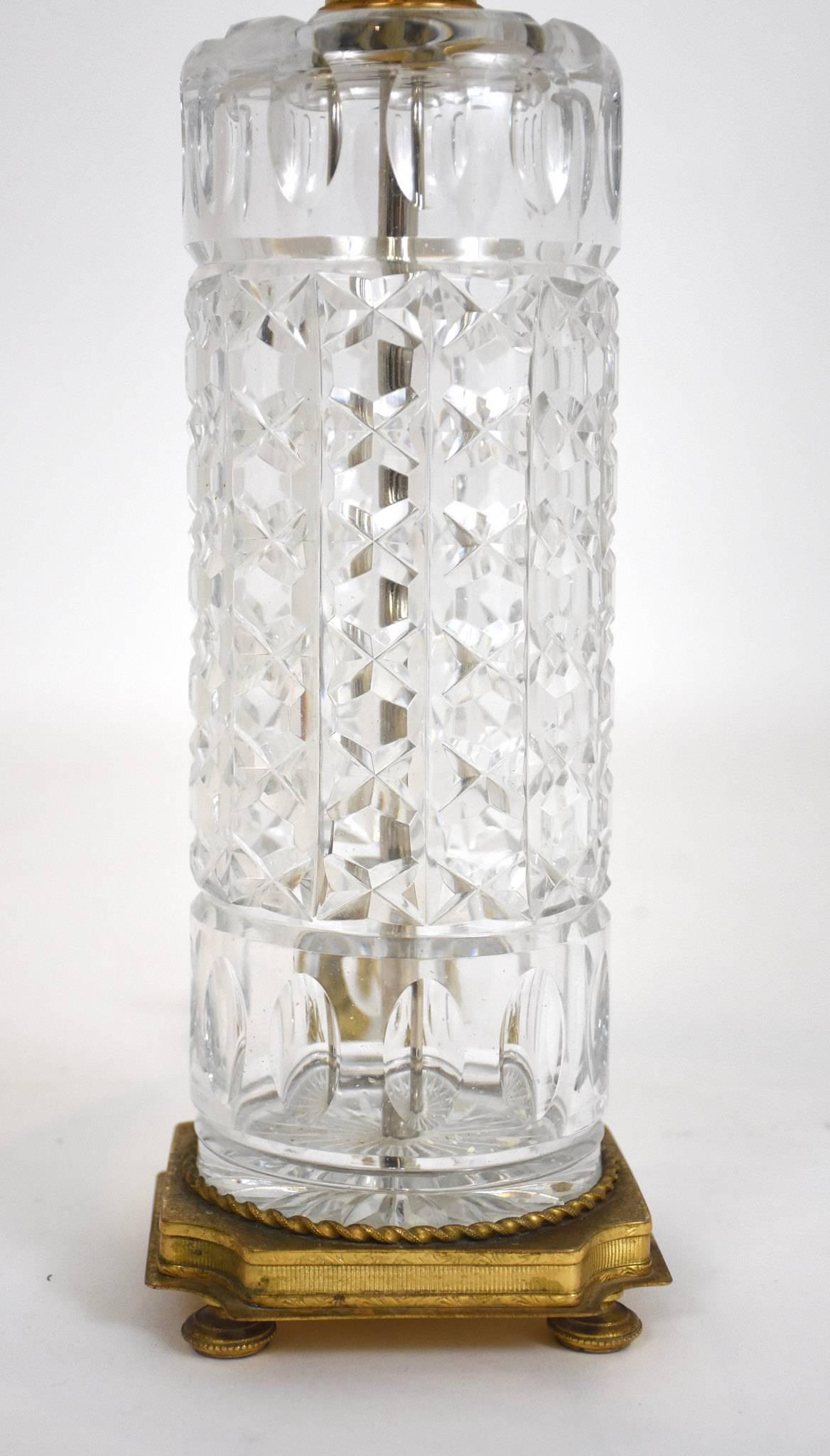 An early 20th century continental cut crystal and bronze doré table lamp with linen shade.

Dimensions:
24” H to top of finial
Shade is 9” H x 12