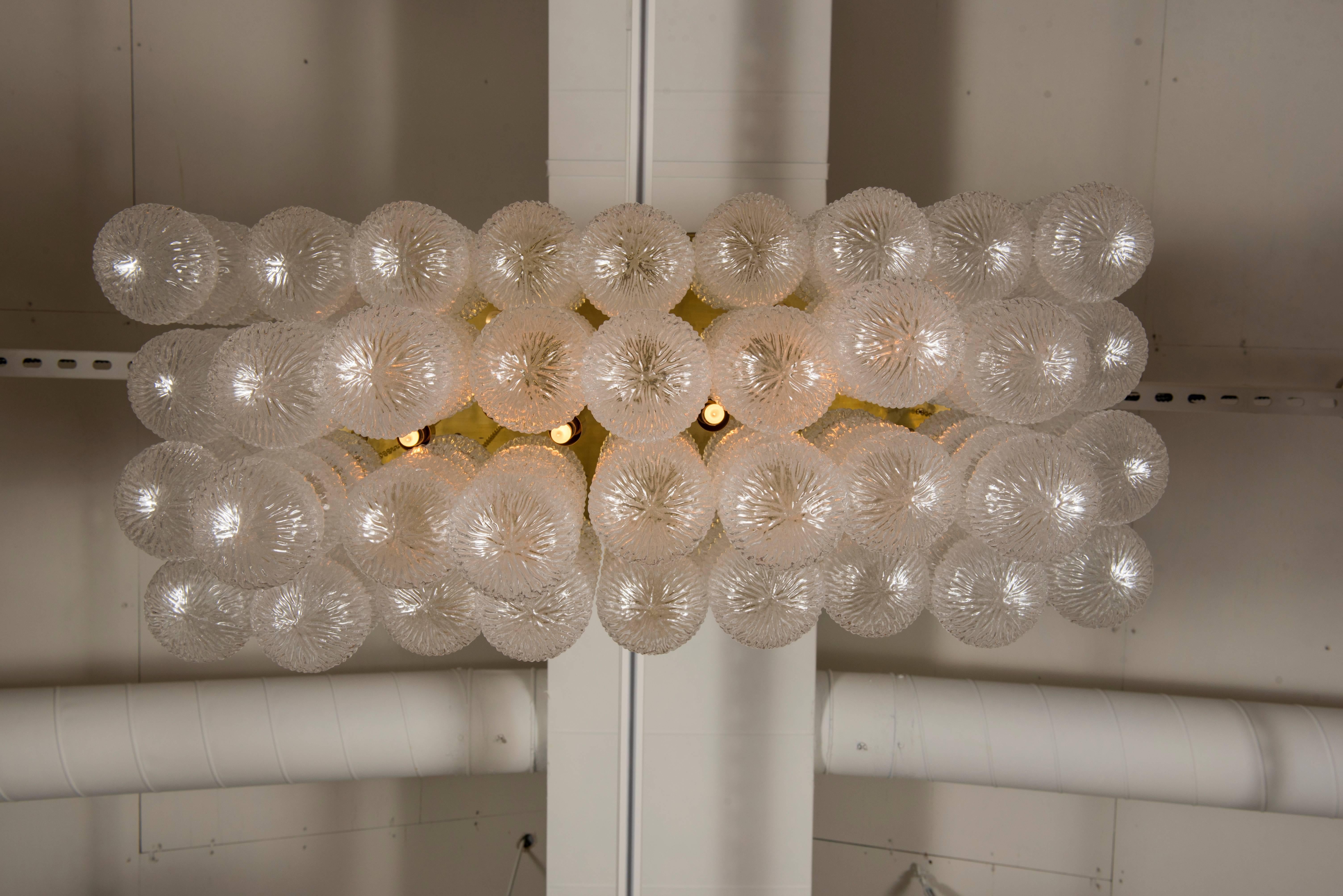 A large-scale vintage Italian Murano chandelier by Seguso. This unique chandelier is a mass of handblown textured elongated glass bubbles each suspended individually from brass chains and a brass frame. This chandelier has been newly wired and has