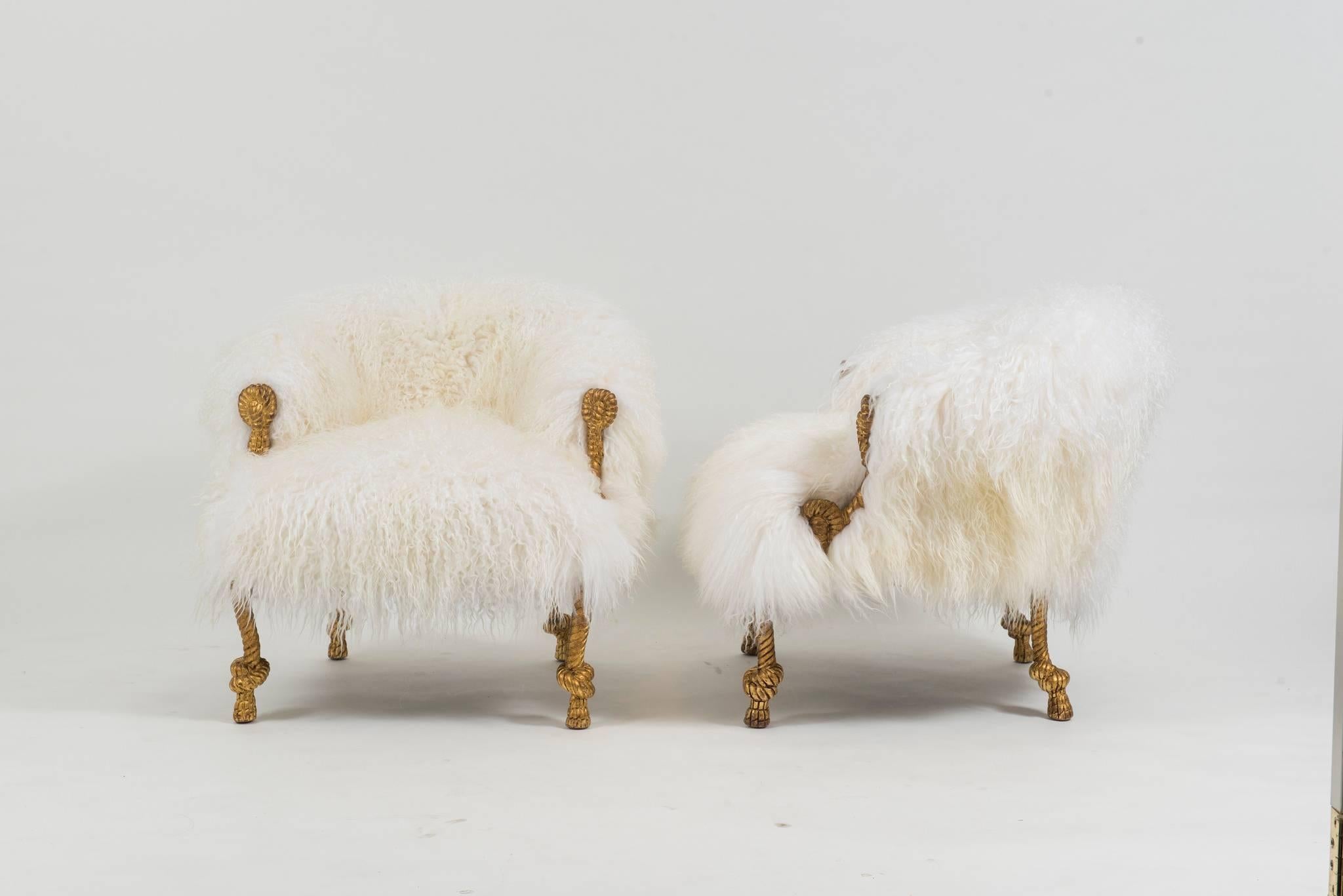 A wildly chic pair of vintage Fournier style gilt carved rope bergeres newly upholstered in a white high quality Icelandic sheepskin fur. The giltwork and carving of rope knots are excellent examples of these Napoleon III style chairs. 

Overall