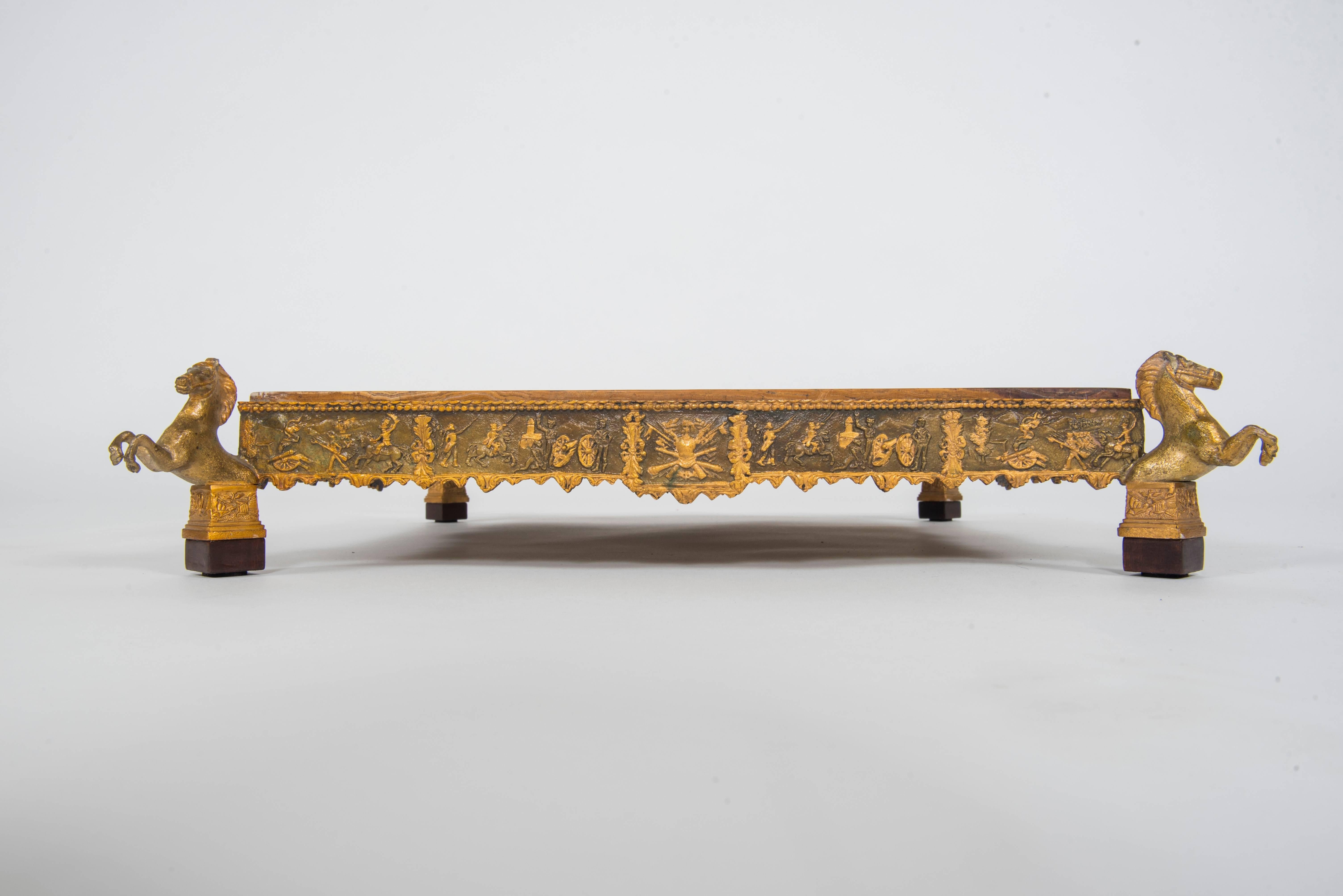 A highly decorative military bronze banded plateau featuring four rearing horses on wood plinths with a cognac/caramel onyx slab.

Measures: Onyx top is 15.63