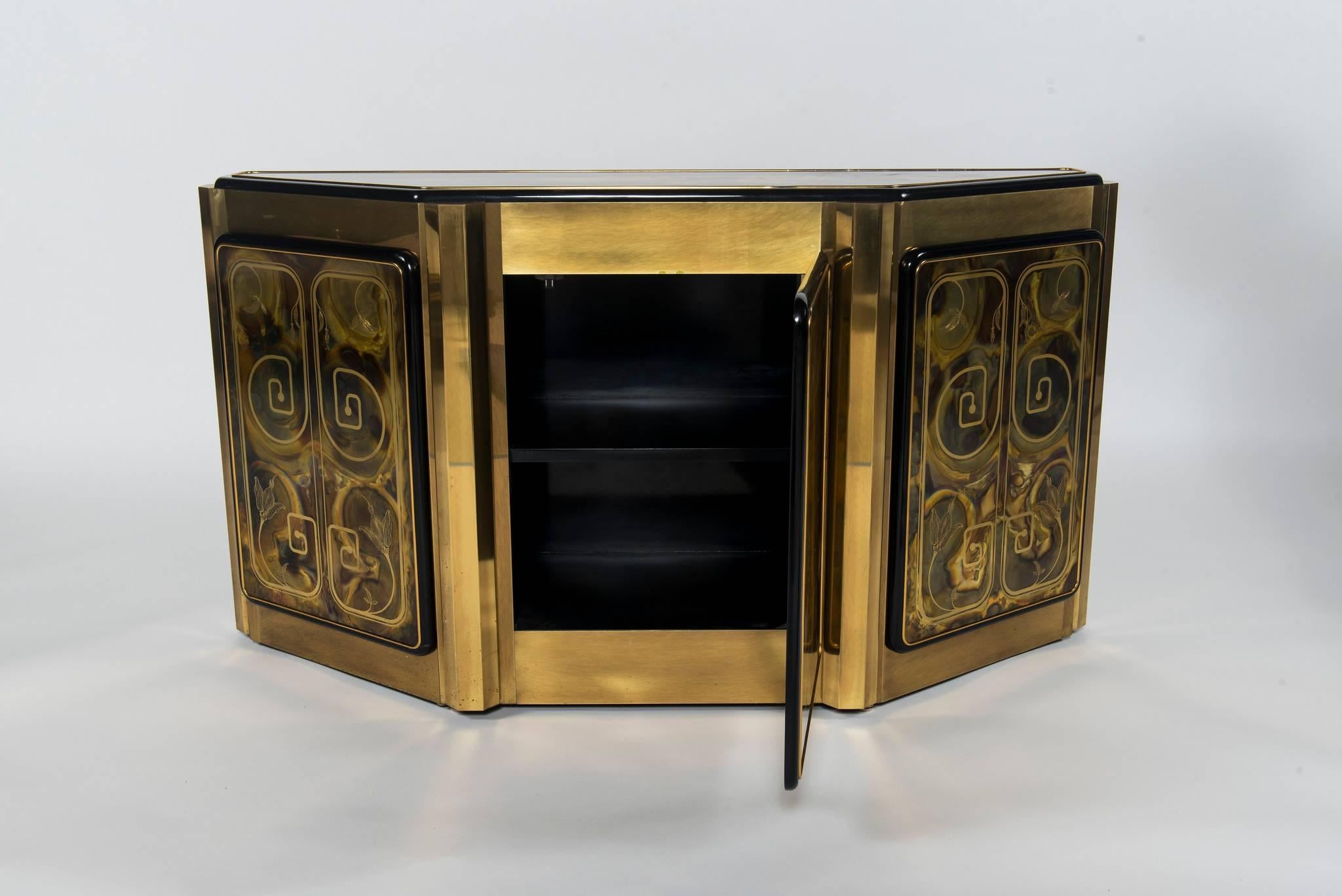 This Mastercraft cabinet features an acid-etched floral design on its unique brass finish. Centre door opens to access a fixed shelf.