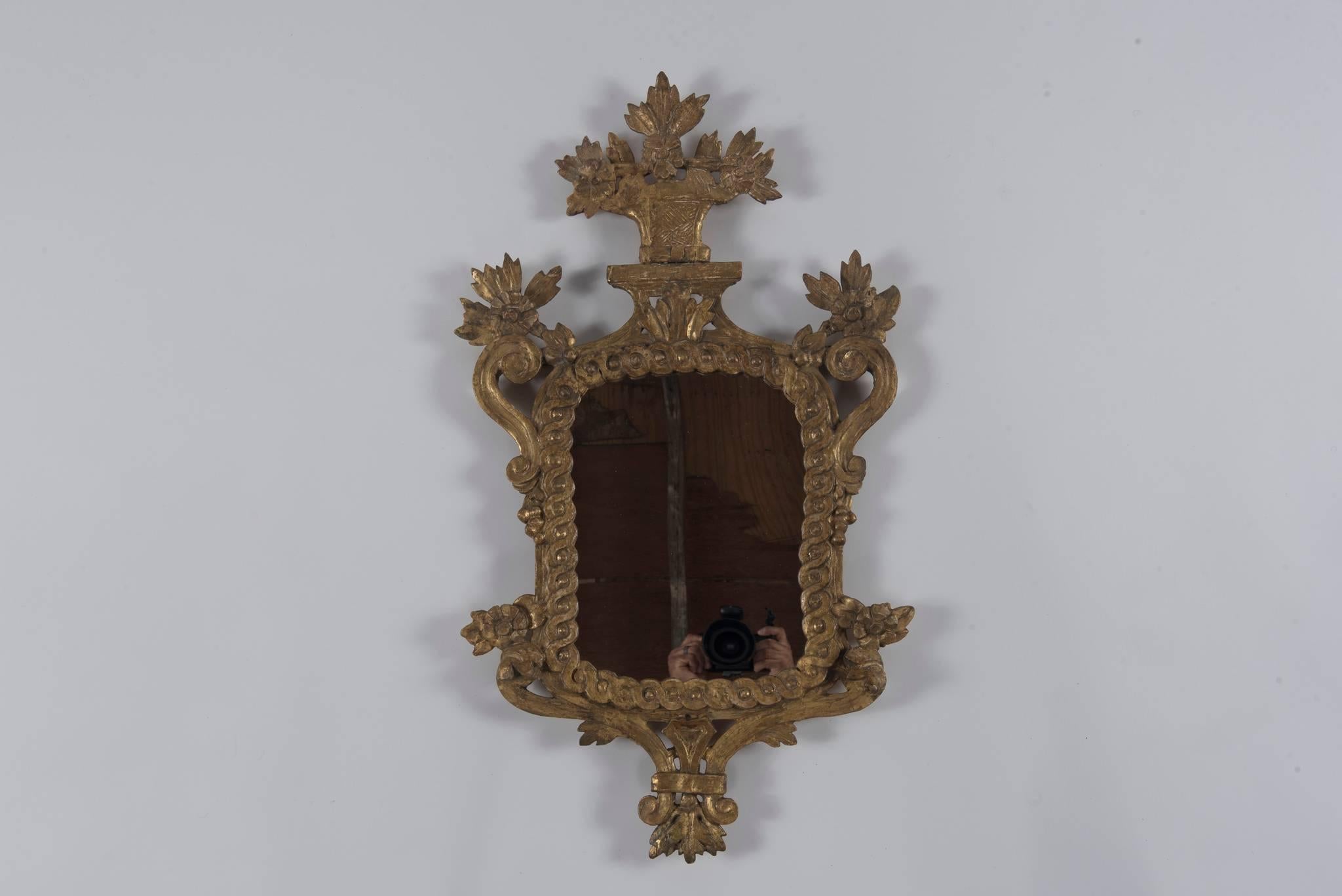 An 18th century Italian Louis XV gilt wood mirror with beautiful patina.