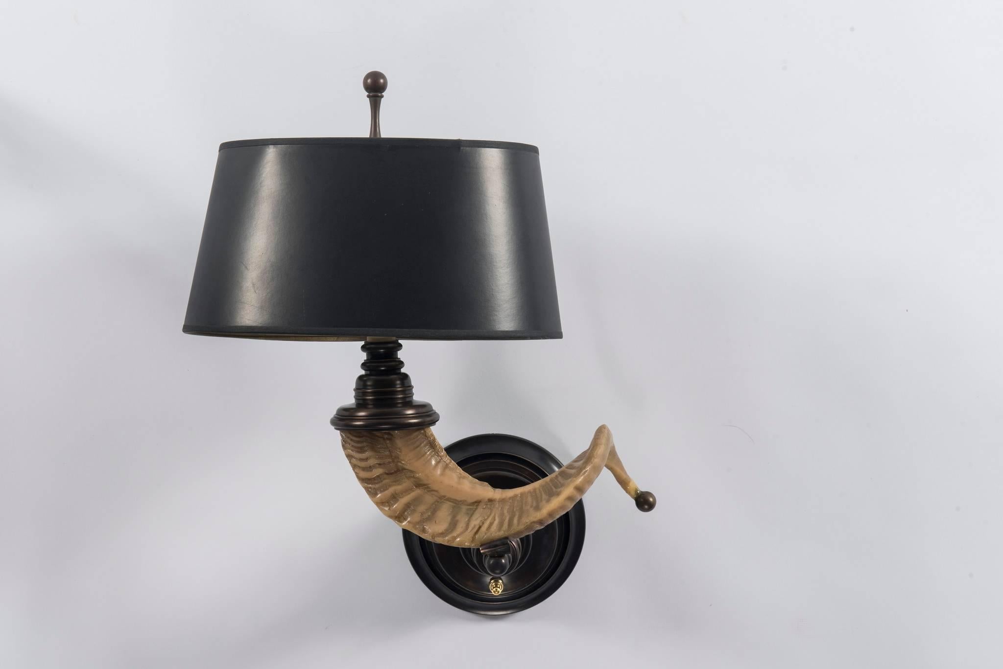 A pair of vintage horn style sconces with brass detailing and original gold marbled black paper shades. These sconces have been newly electrified.