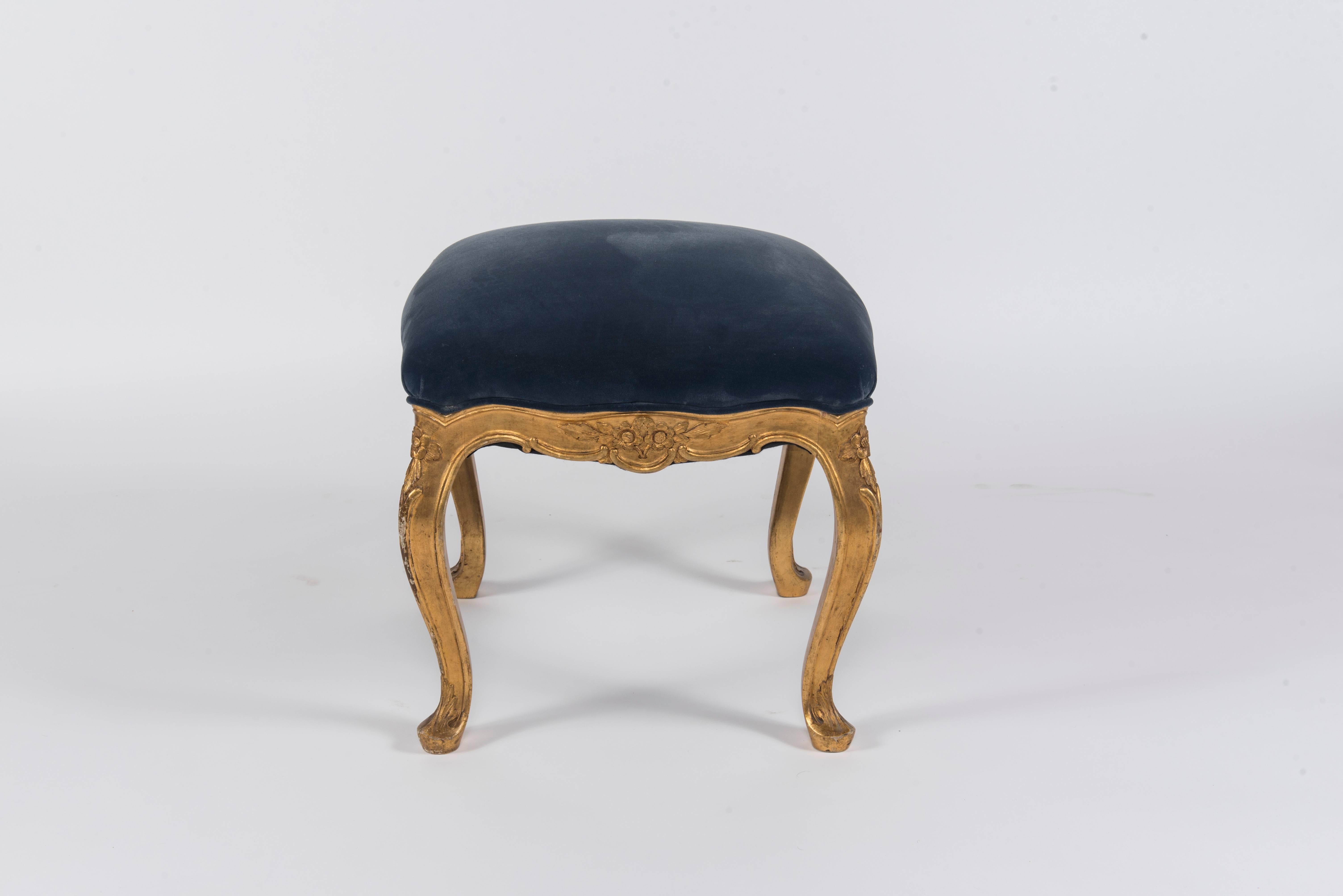 19th century French Louis XV style giltwood ottoman, newly upholstered in a Prussian blue velvet.