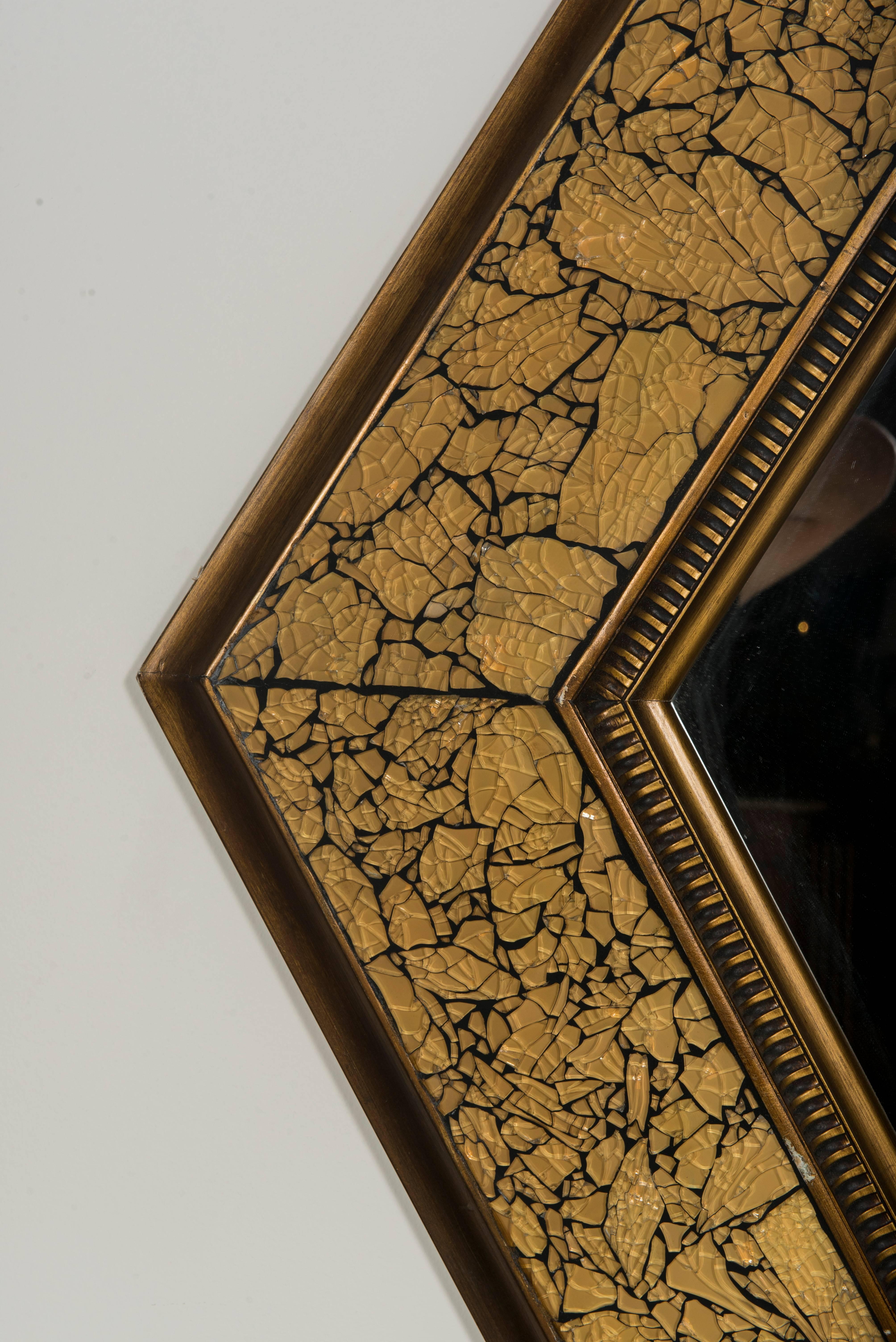 A midcentury diamond shape mirror with decorative crackled gold frame.