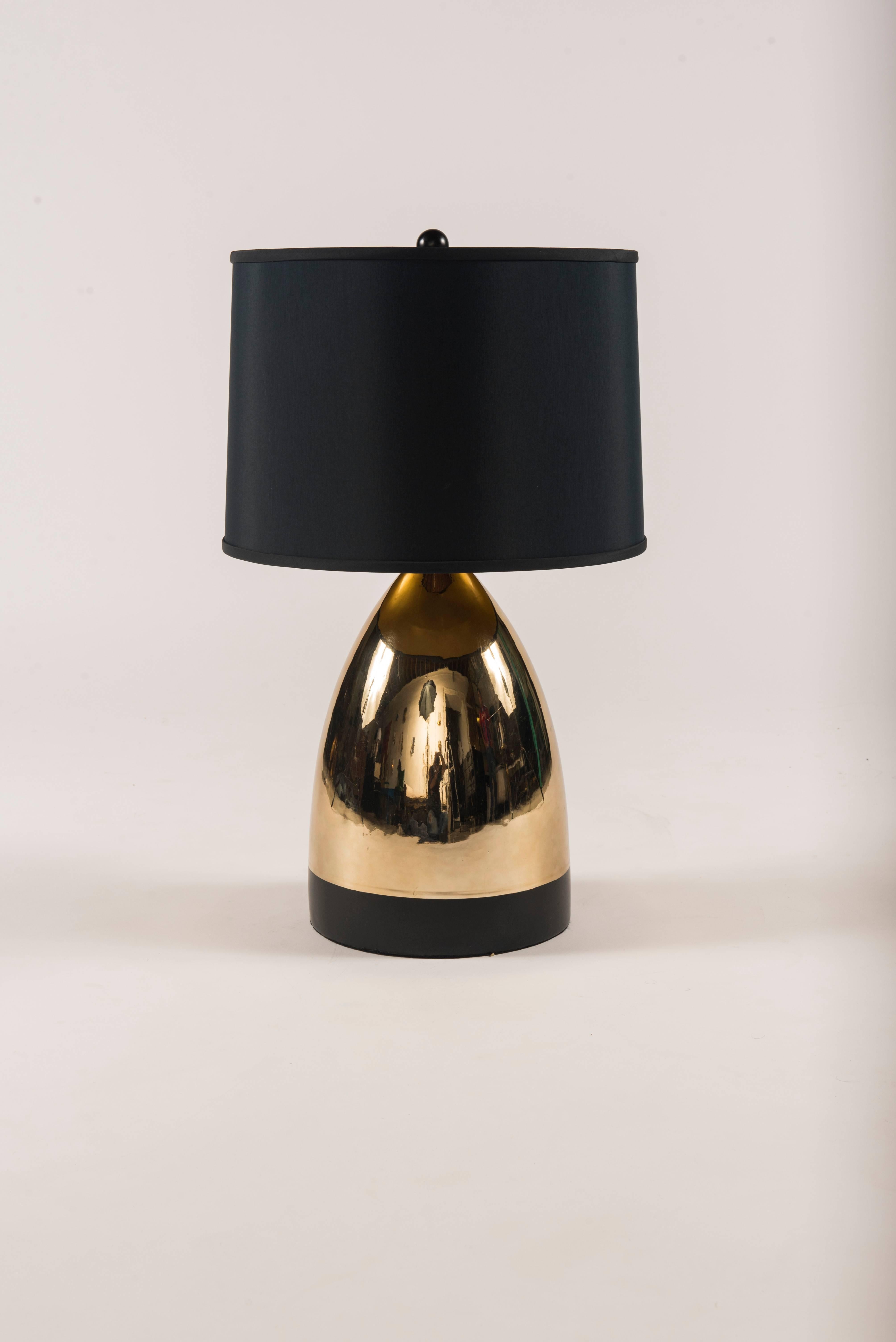 A 1970s pair of fire glazed gilt ceramic lamps with black enamel banding and black shades, newly electrified.