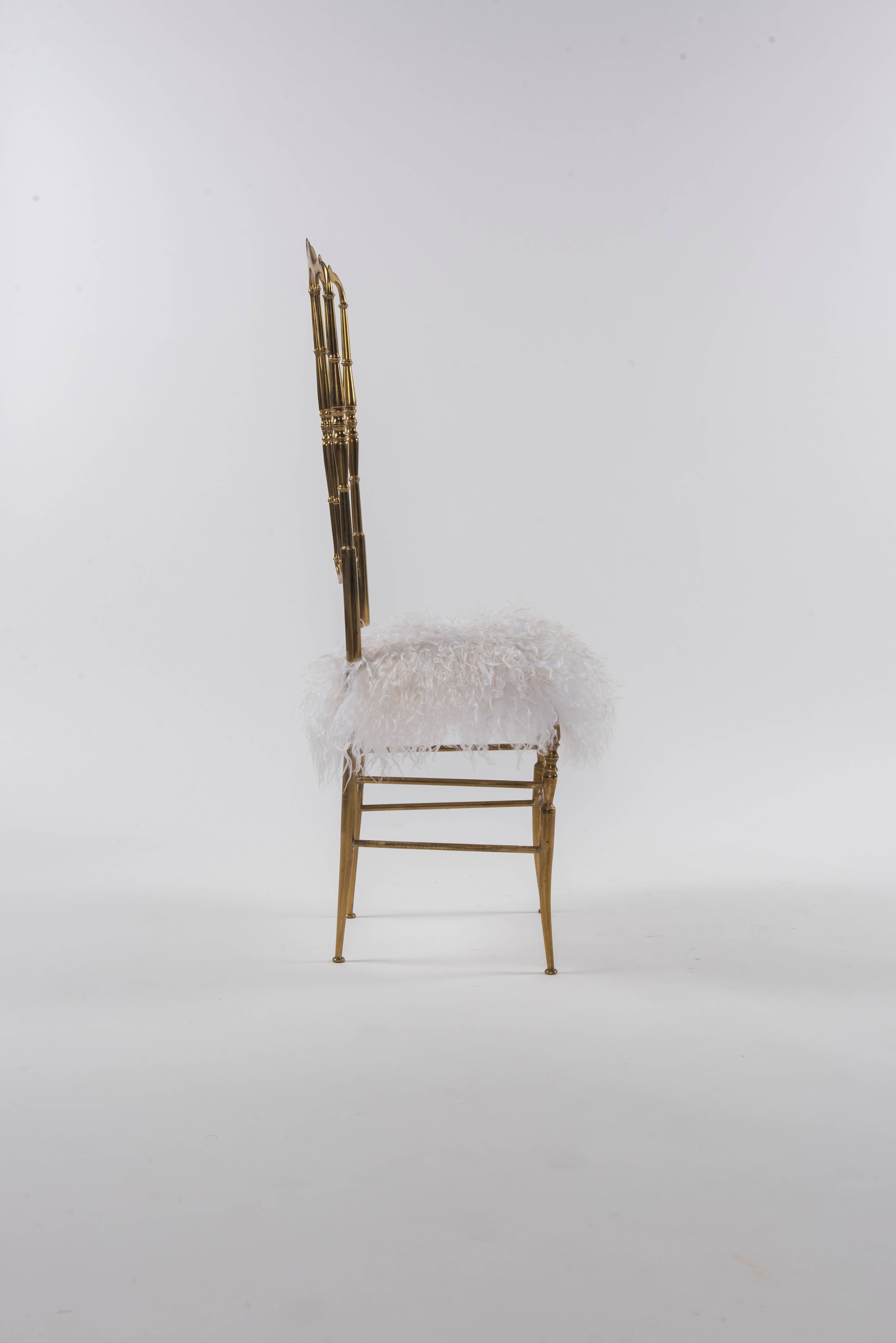 A vintage tall back Italian brass Chiavari chair newly upholstered in a snowy white Icelandic sheepskin fur.