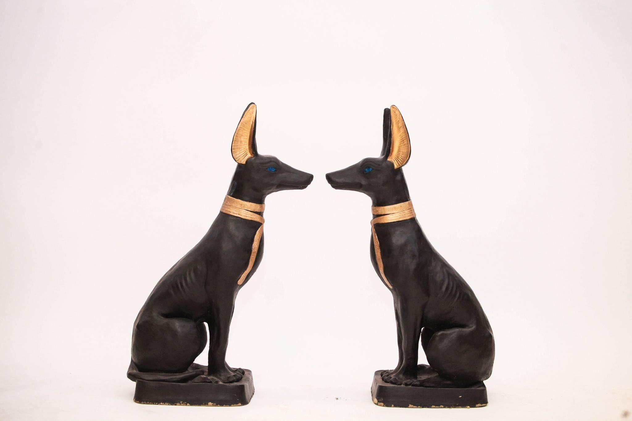 Vintage pair of large painted Egyptian Anubis guardian dogs. These black beauties have golden ears and ties with blue eyes.