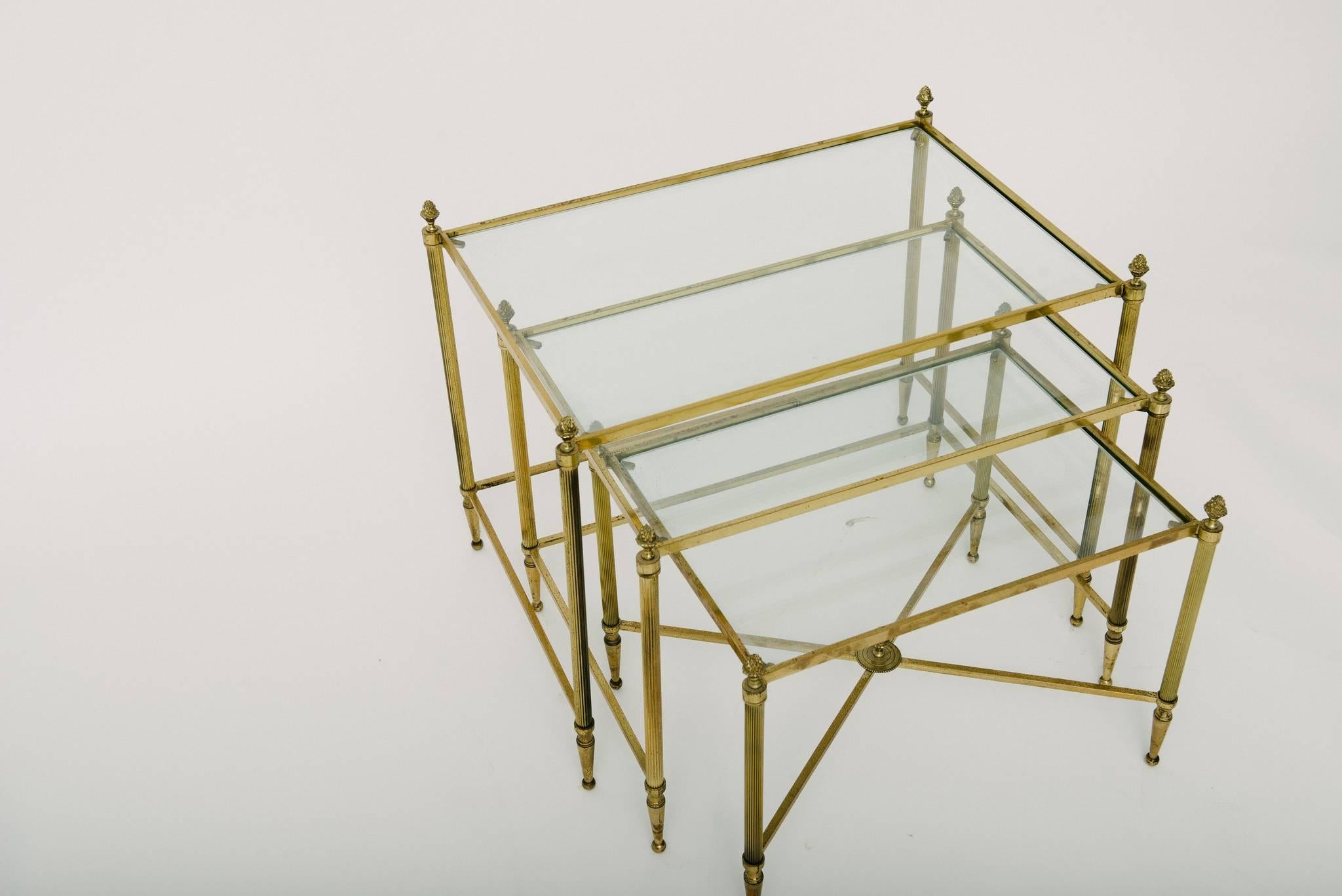 Set of three vintage petite French brass and glass nesting tables with pineapple detail.