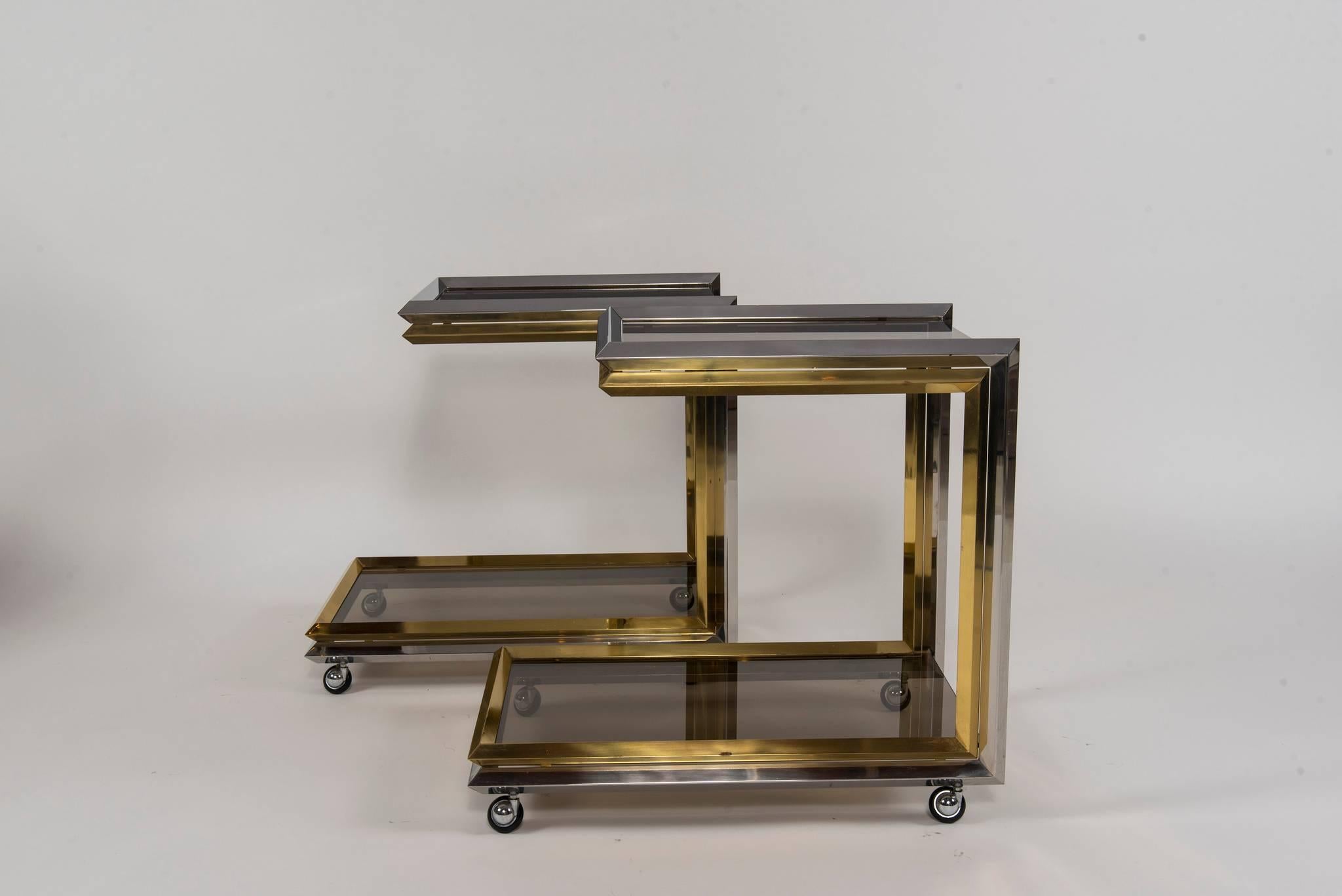 Vintage chrome, brass and smoked glass two-tiered bar carts. Two available, sold individually. $3800.00 each.
