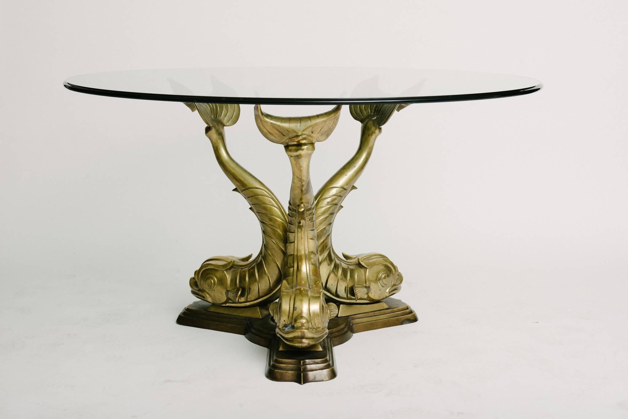 Vintage brass dolphins dining or center table base shown with 54