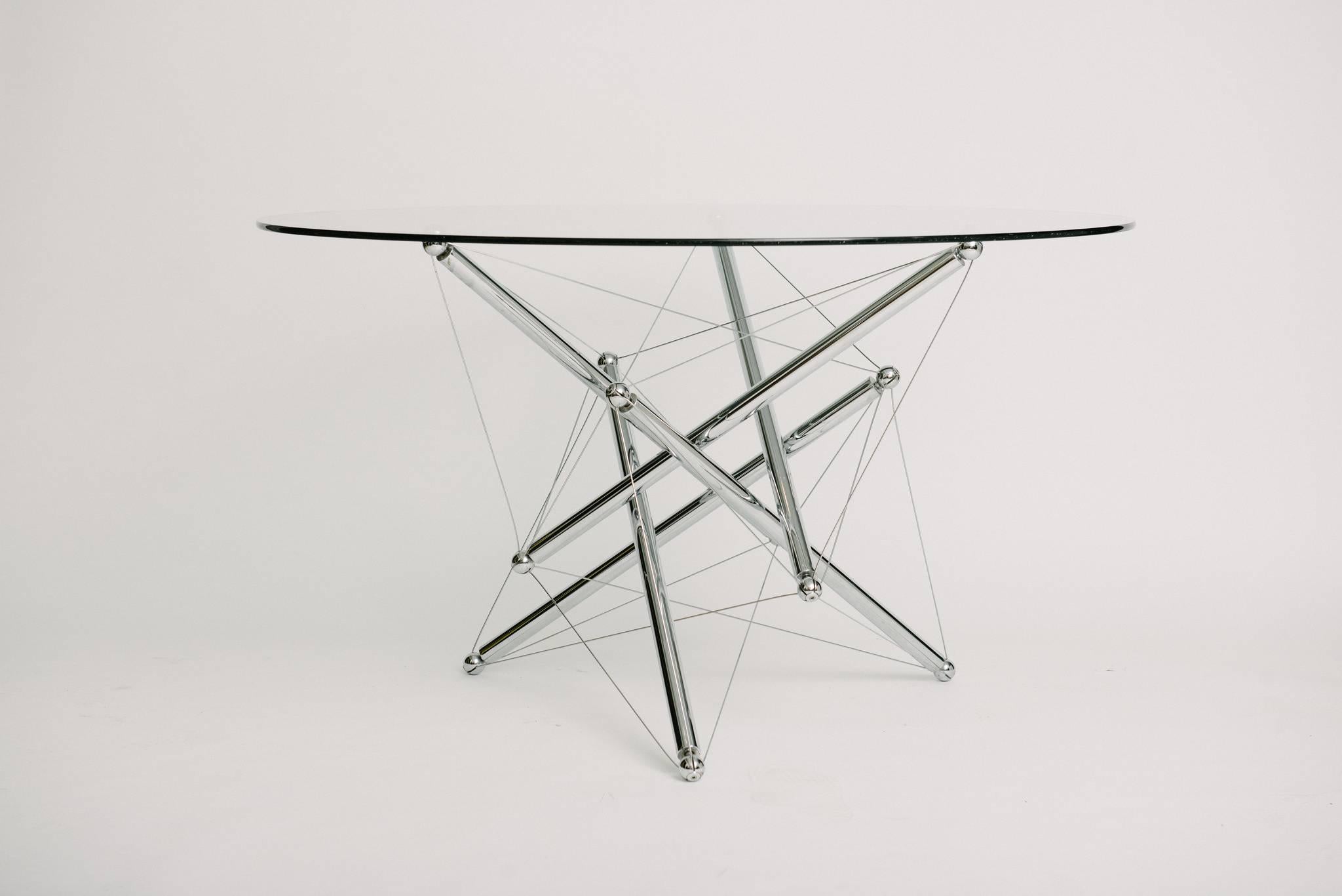 Dining table base designed by Theodore Waddell for Cassina in 1972. 

The table base is polished chrome-plated steel with steel tension wires.

Tensegrity is the characteristic property of a stabile three-dimensional structure consisting of