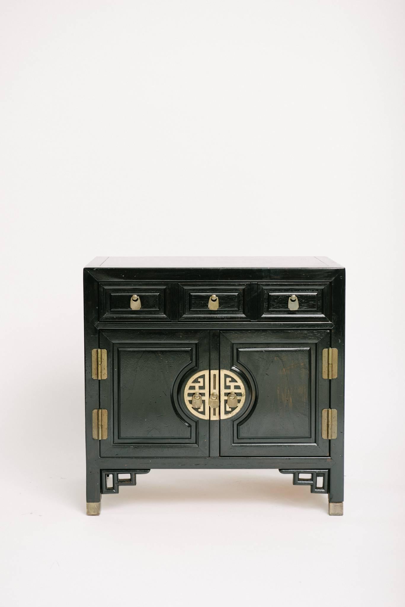 Pair of Chinese Chippendale cabinets by Ray Sabota. Accentuated by chunky Greek key brass hardware and faux bamboo style fretwork trim. Manufactured by Century Furniture. Great as nightstands or end tables.
