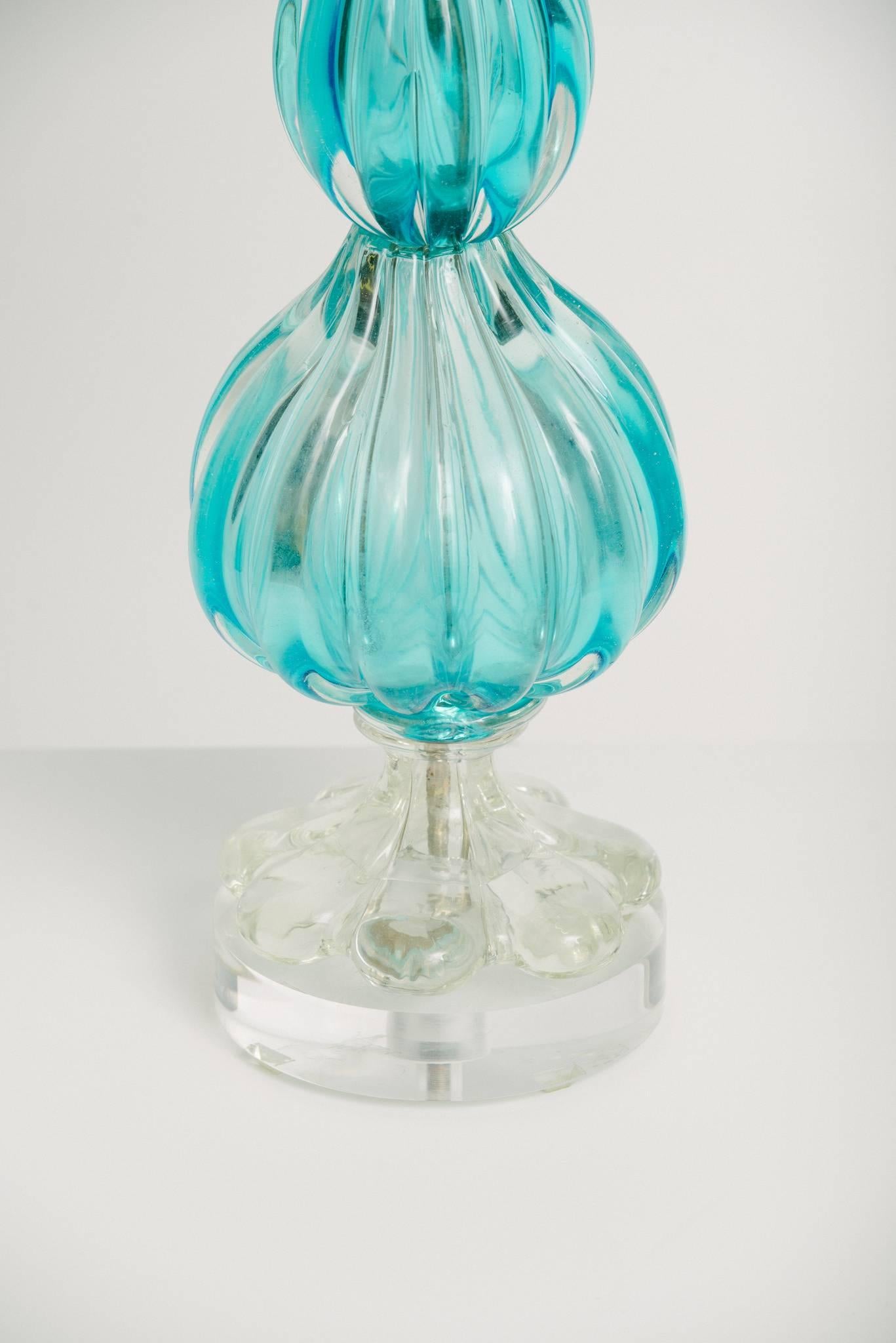 A vintage blue Murano glass table lamp on Lucite base with white linen 16'' drum shade.