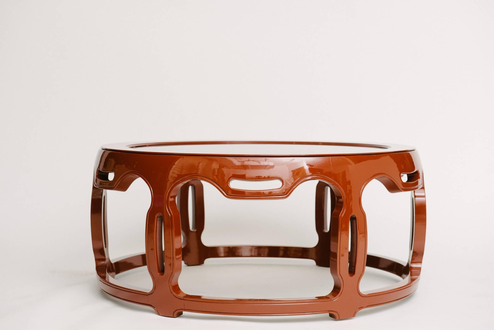 An early 20th century carved Ming style drum table with beveled glass top, newly restored in a beautiful deep burnt sienna color with a gleaming high gloss 
