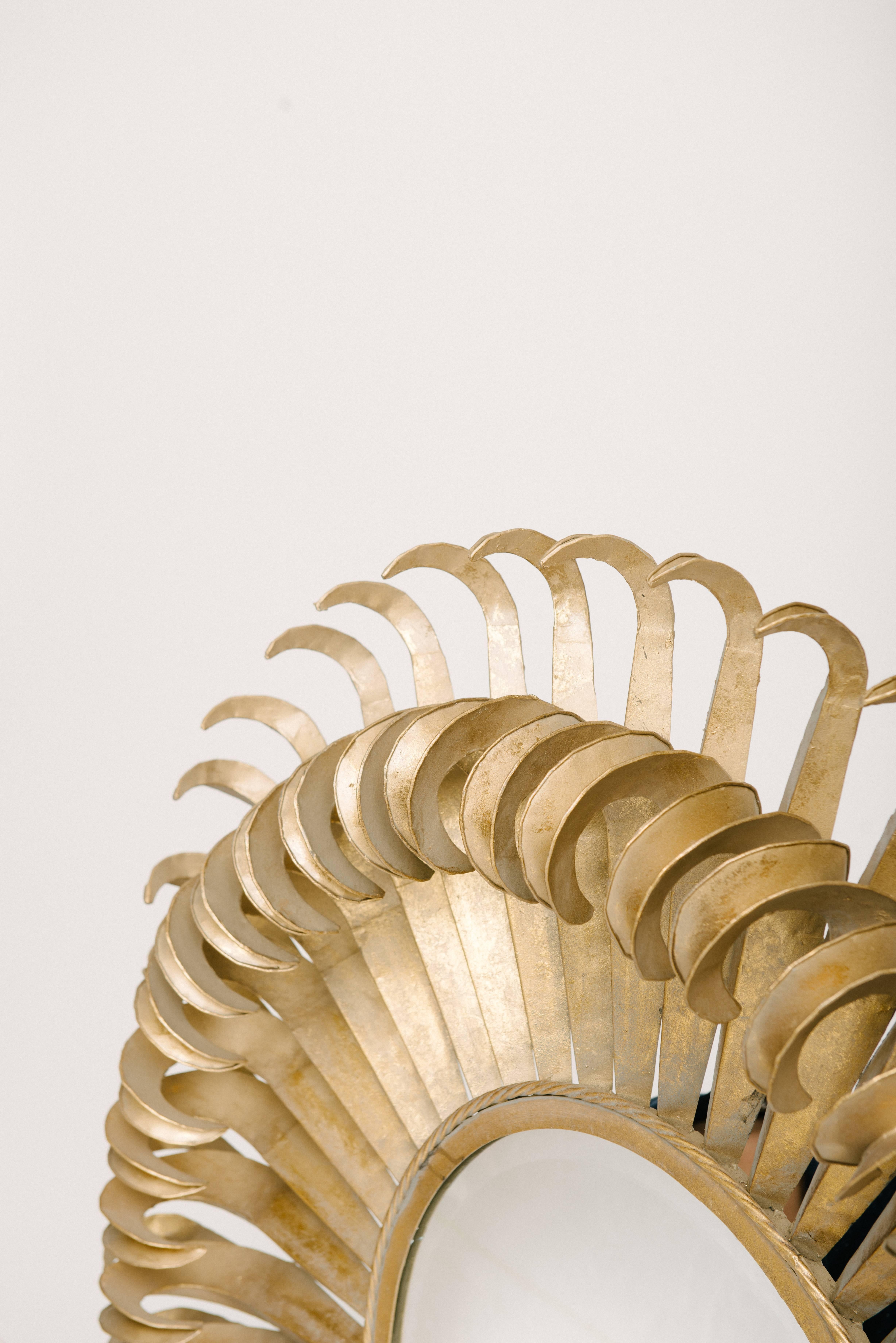 A bold and distinct pair of French gilt sunburst beveled eyelash mirrors. Measures: 49
