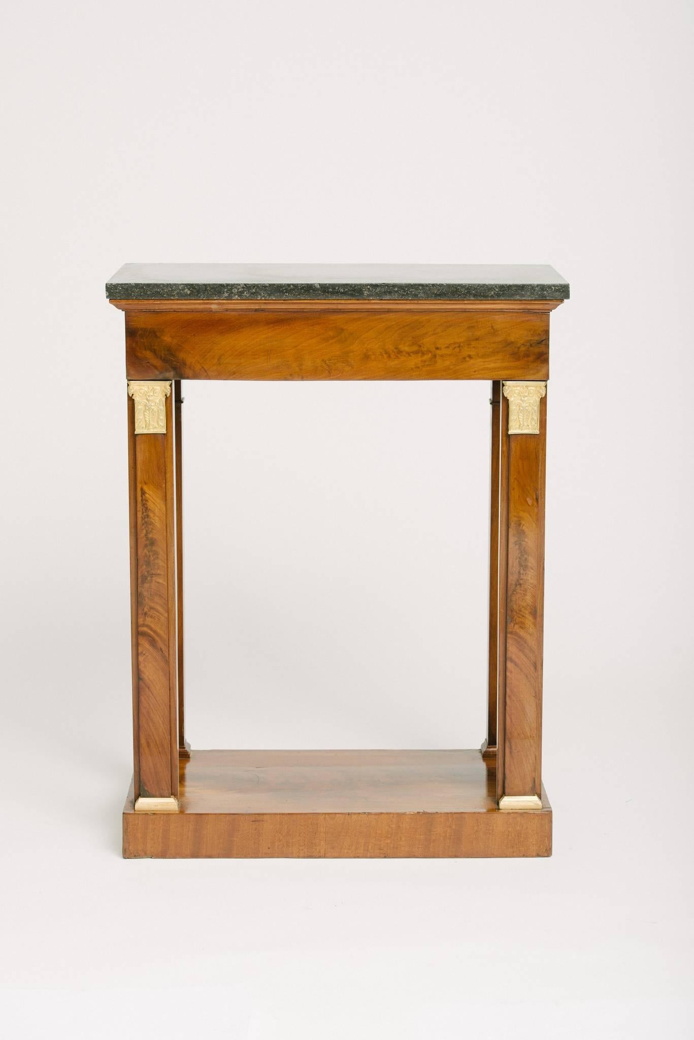 19th century French restoration walnut single drawer console table with black marble-top and gilt ormolu detail.