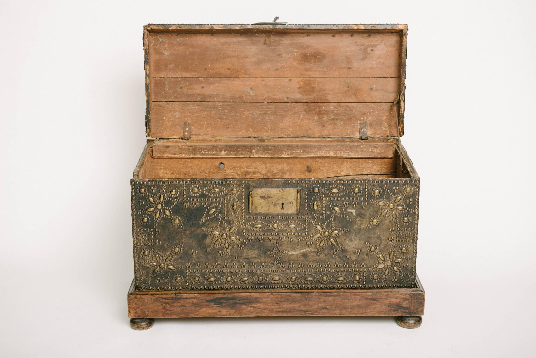 Französische Lederkiste, Truhe oder Koffer aus dem 17. Jahrhundert mit weinrotem Nagelkopf auf neuerem Holzsockel.
  