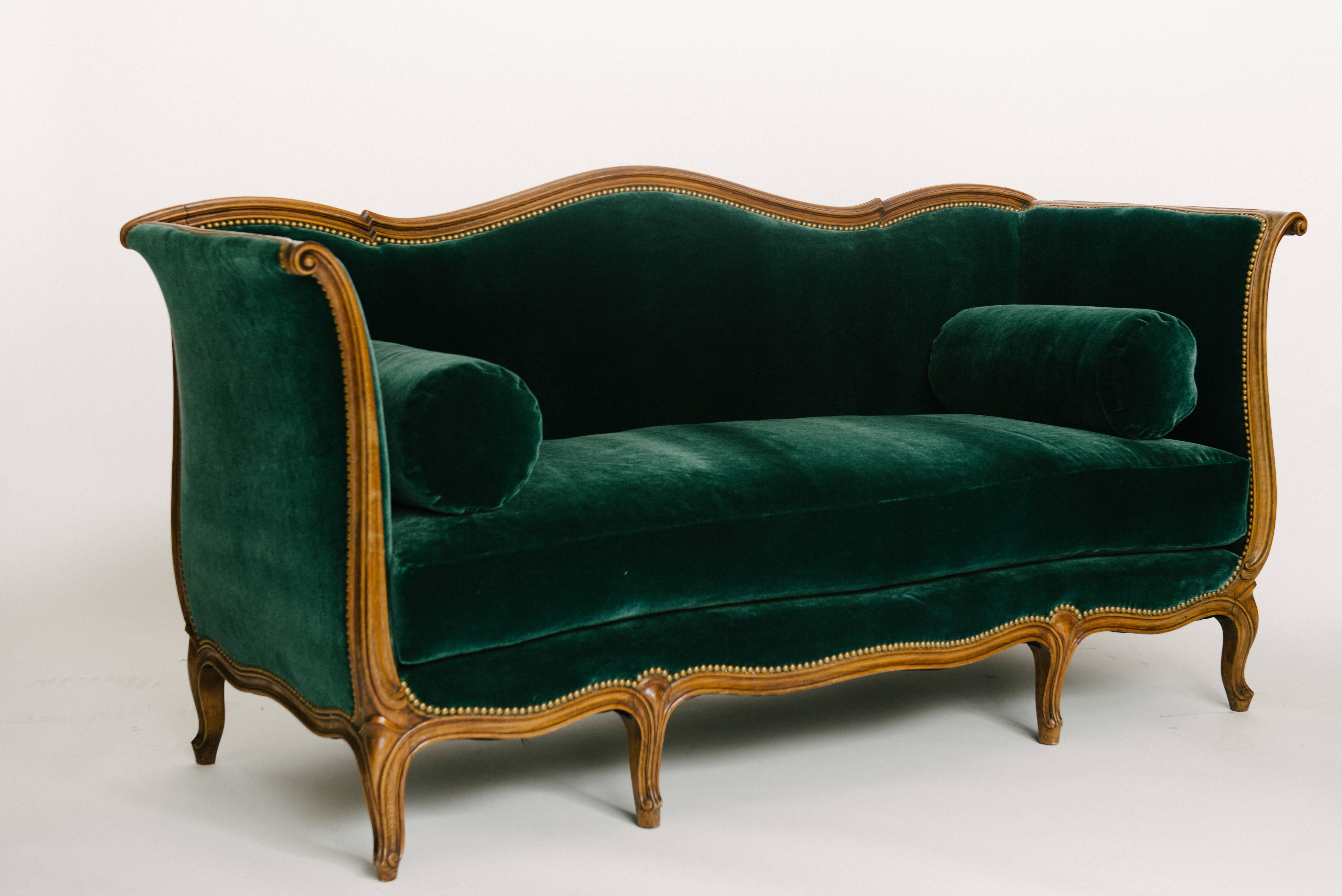 An elegant 19th century carved Louis XV style Sultanes sofa newly reupholstered in an dark emerald green mohair with French nailhead detail. Seat is fabricated with feather/down wrapped spring coil cushion.