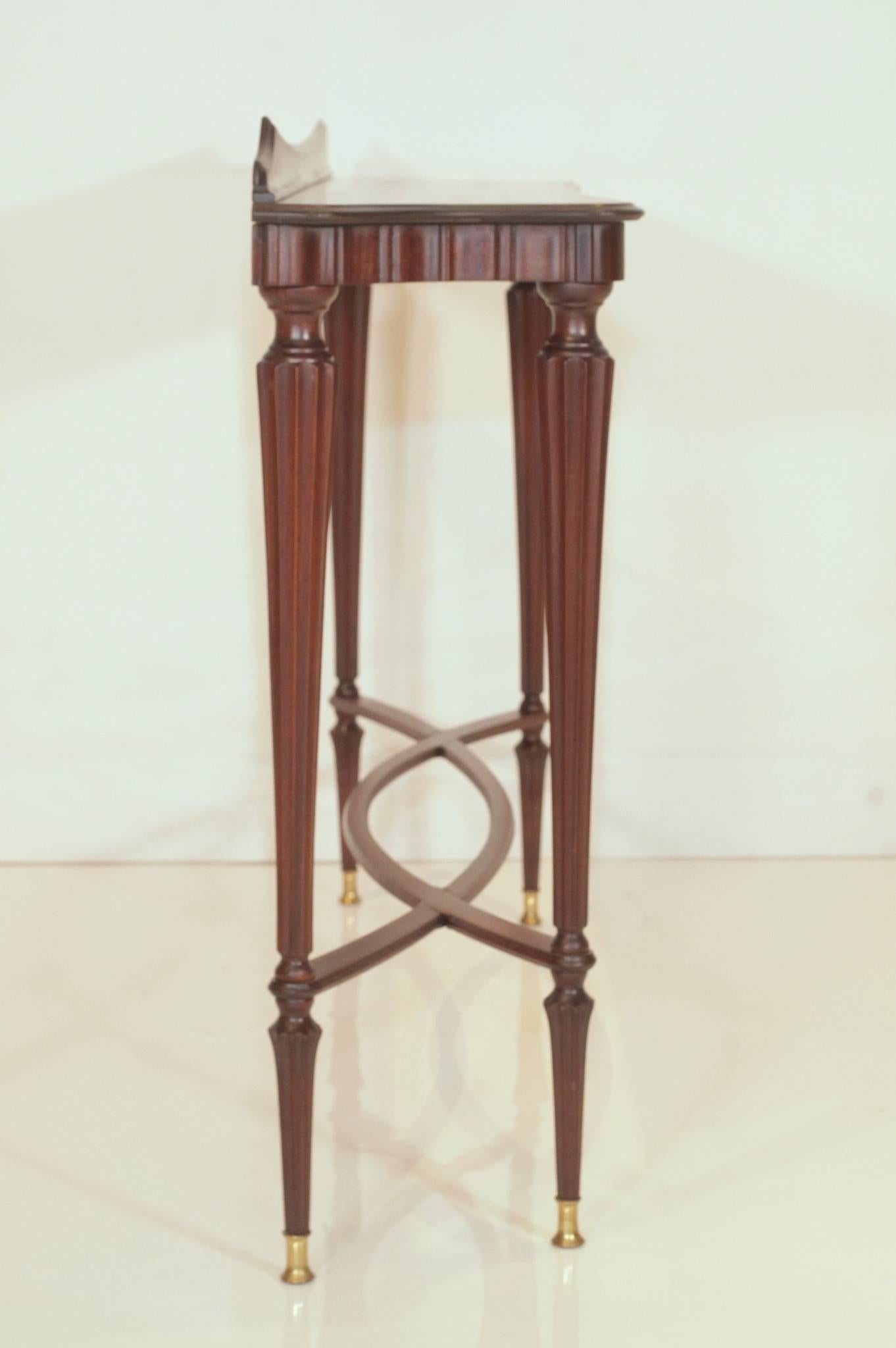 Italian sculpted walnut console table with cross bands and bronze sabots by Paolo Buffa, circa 1945.