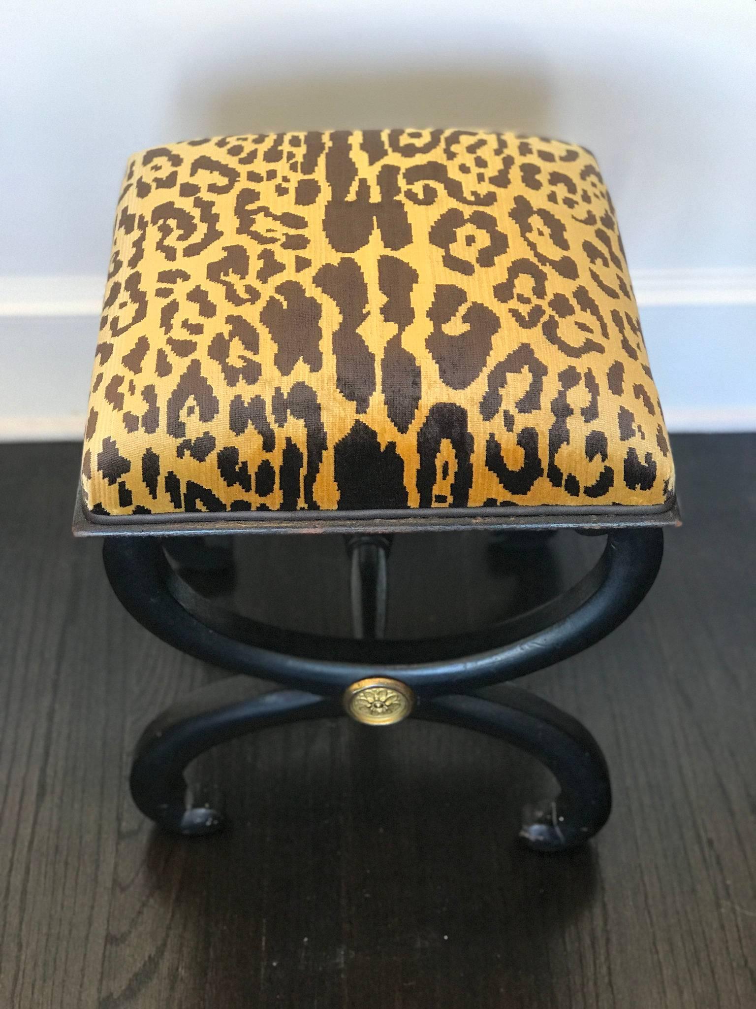 A 19th Century ebonized carved wood curule tabouret with ormolu newly upholstered in an exquisite leopard silk velvet and espresso leather trim welt. This item ships easily in a box to worldwide destinations.