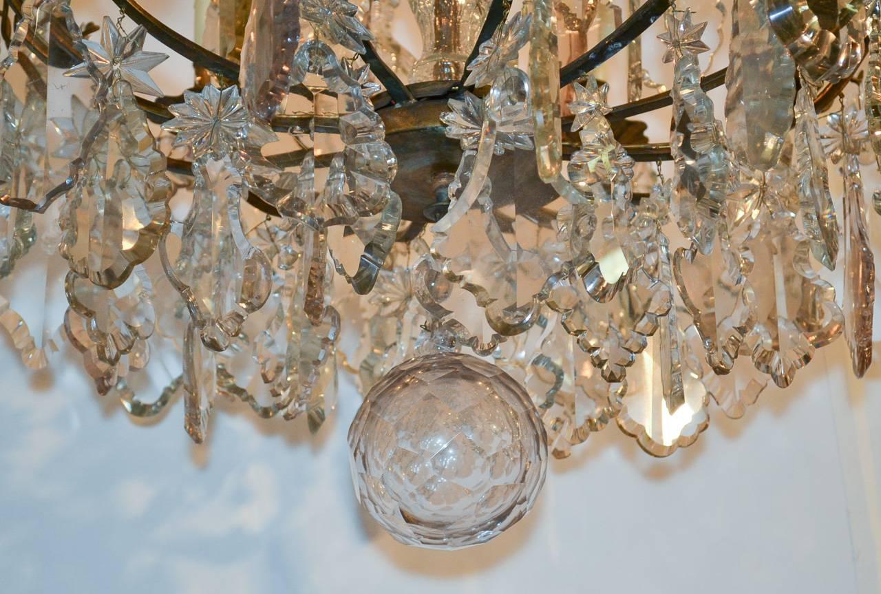 Wonderful 19th century French bronze and crystal six-light chandelier. Beautifully adorned with numerous pendeloque, star and rose prisms. Having a lovely central column, large finials and faceted drop ball. 

