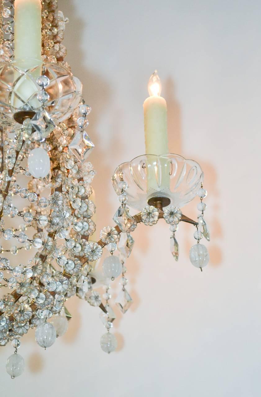 Gorgeous 19th century Italian beaded six-light chandelier. Having intricate beading throughout, the frame and arms embellished with rosettes and adorned with rock crystal drop prisms. 