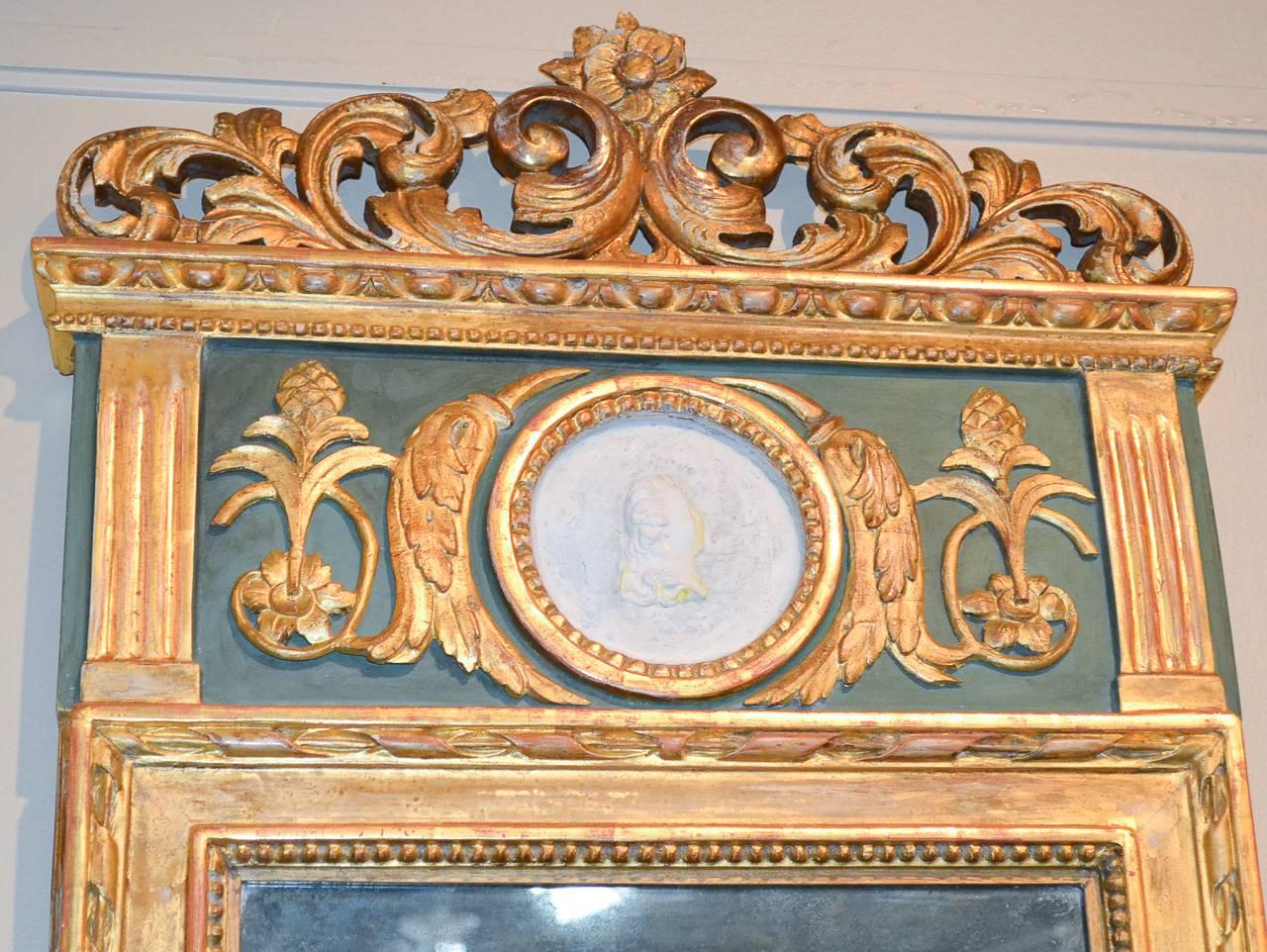 Marvelous 19th century Swedish hand-carved and parcel-gilt mirror circa 1850. Having hand-carved cartouche and frame in acanthus leaf motif, bisque portrait plaque of lady, painted an parcel-gilt beaded frame and with original mirrored glass.