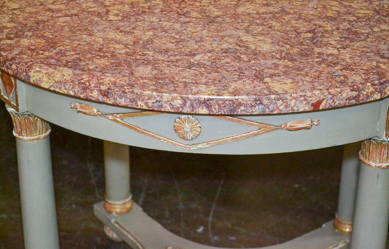 Beautiful French Empire painted and parcel-gilt occasional table with Brocatelle Violette d'Espagne marble top. Having wonderful carved details in acanthus leaf and classical motifs, column form legs and resting on bunn feet. 