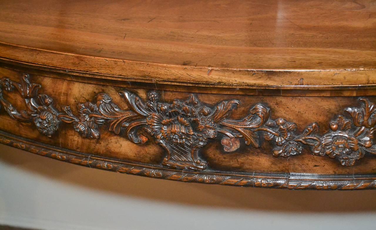 Magnificent 18th century period Georgian faded mahogany sideboard. Having shaped front with finely carved drawer in floral and foliate motif, detailed carved legs, and a superb patina. A Classic of quality and craftsmanship.