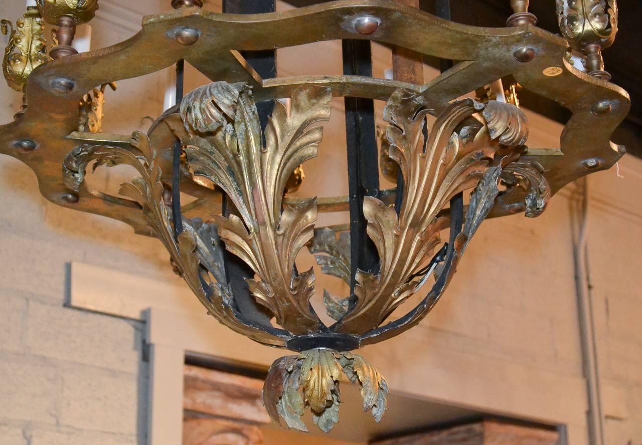 Sensational 19th century French iron twelve-light lantern. Having iron frame adorned with gilt acanthus leaf motif decoration, candle cups in leaf form, and a beautiful aged patina.