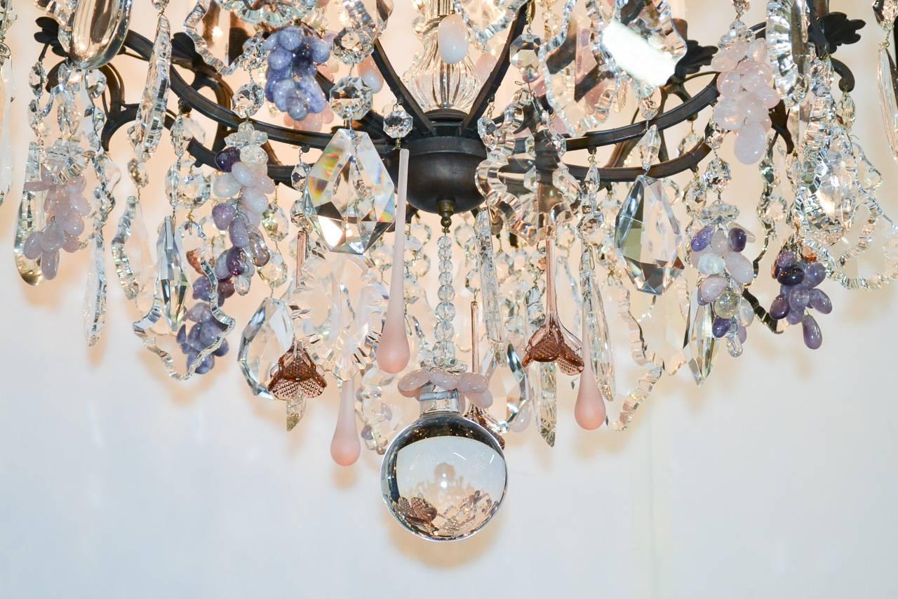 Fabulous 19th century crystal, rose quartz, and amethyst chandelier. Having eighteen-lights, intricate bronze frame, and accented with amethyst grape clusters. 

 