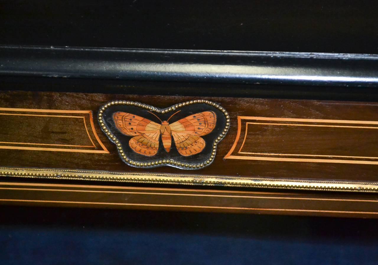 Fantastic pair of 19th century French Napoleon III ebonized and inlaid bookcases. Having wonderful inlaid detailing with intricate butterfly inlays, bronze mounts, and black lacquered sides and top. Wonderful for numerous designs!